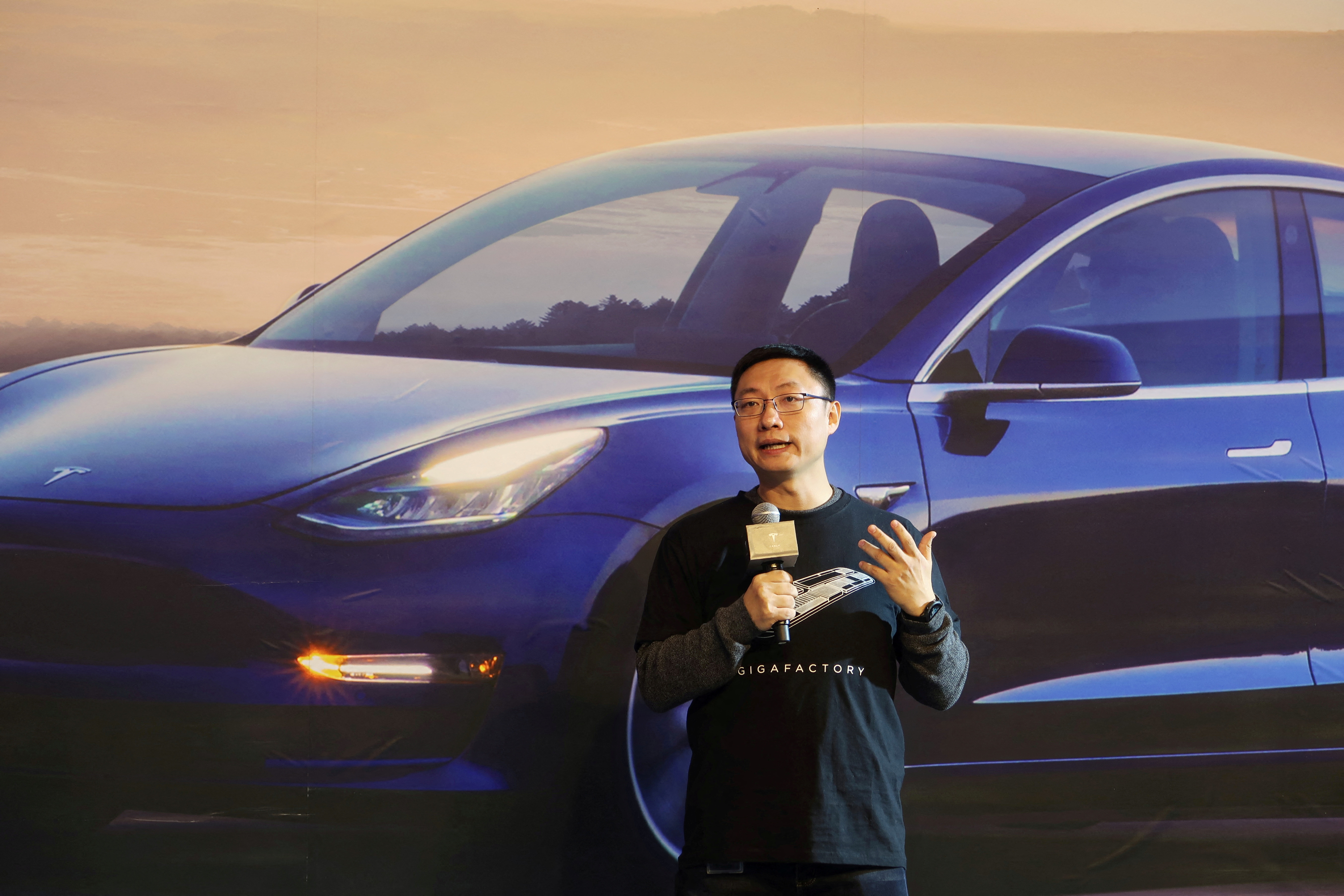Tesla's China chief Tom Zhu speaks at a delivery ceremony for China-made Tesla Model 3 vehicles in the Shanghai Gigafactory of the U.S. electric car maker in Shanghai