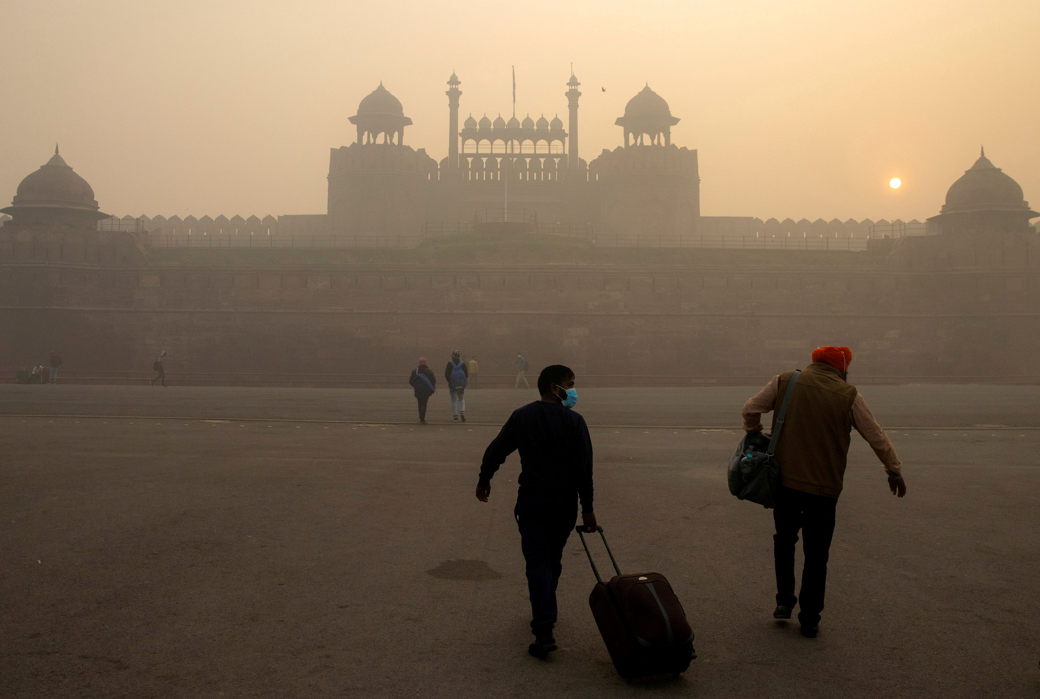 FILE PHOTO: People arrive to visit the Red Fort on a smoggy morning in the old quarters of Delhi, India