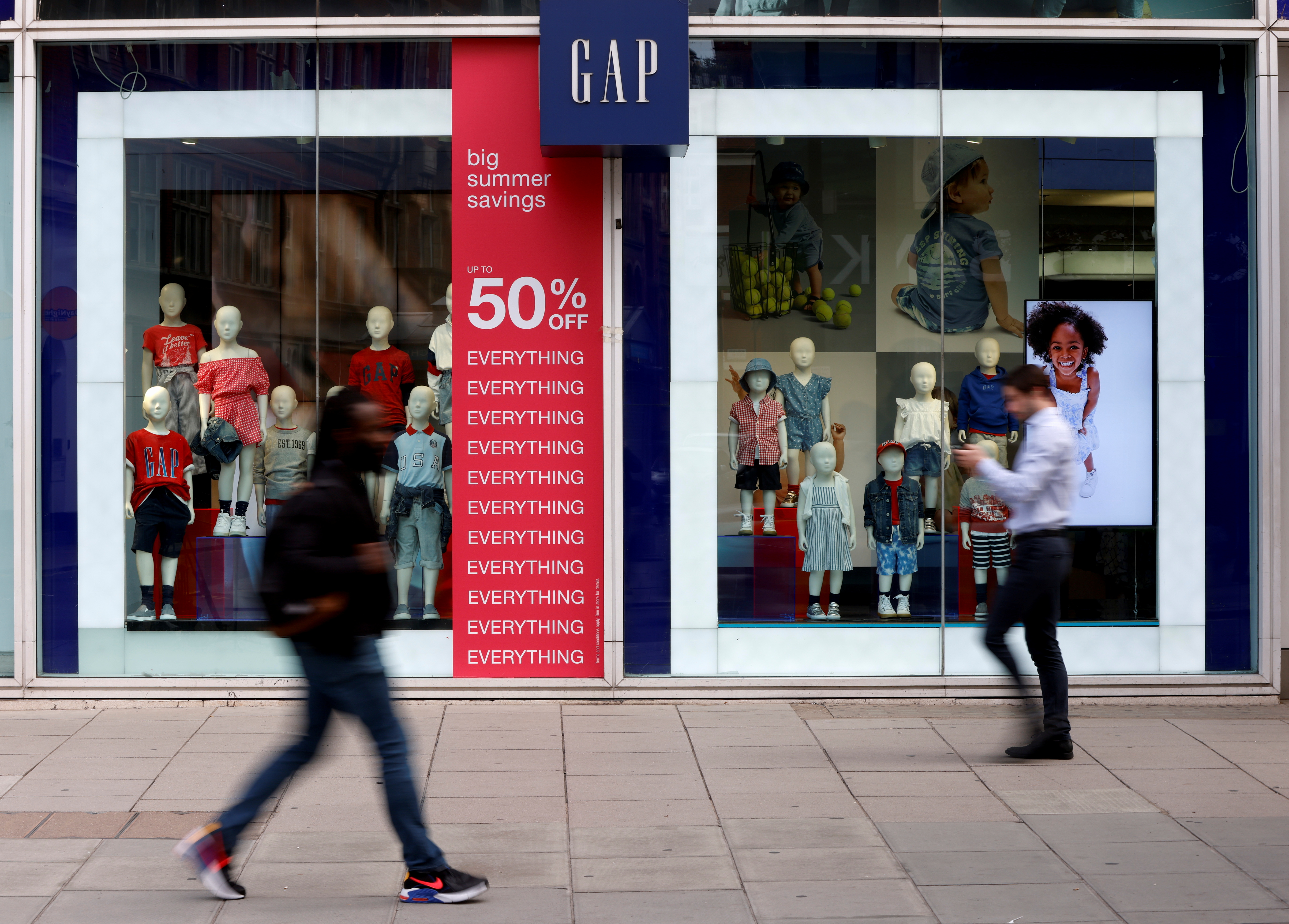 People walk past a Gap store on Oxford Street in London
