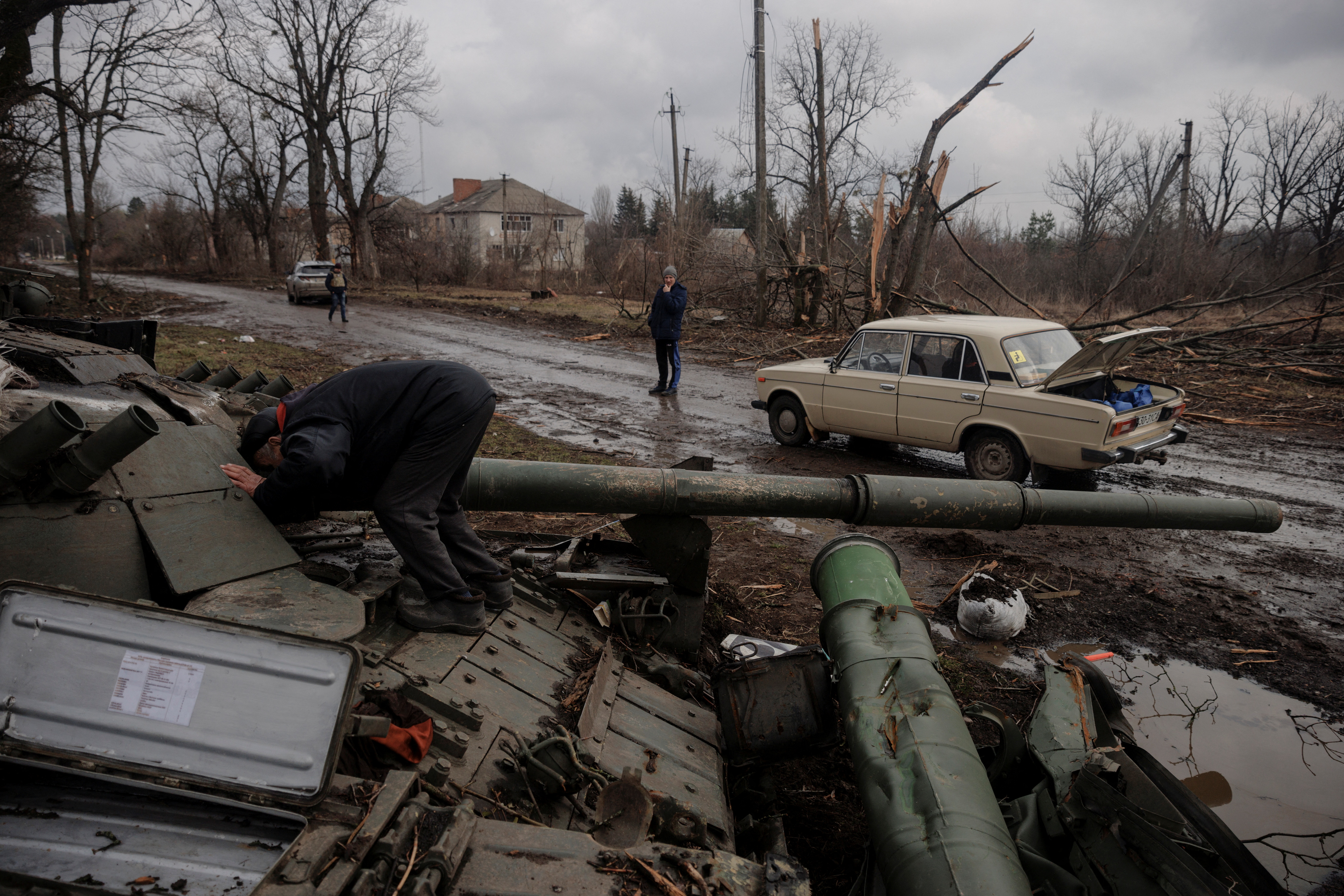 A local man looks into a Russian tank left behind after Ukrainian forces expelled Russian soldiers from the town of Trostyanets which they had occupied at the beginning of its war with Ukraine