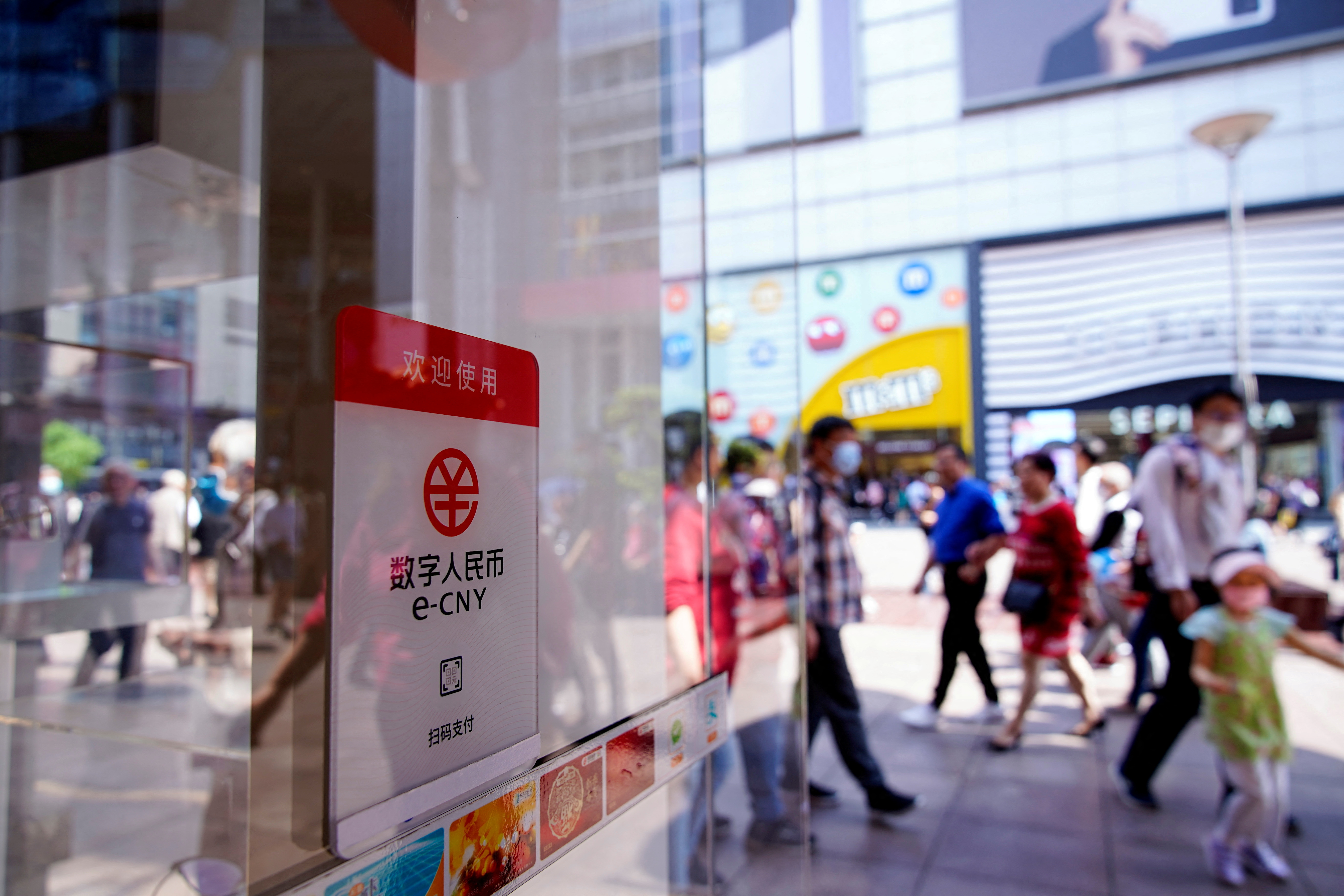 A sign indicating digital yuan, also referred to as e-CNY, is pictured at a shopping mall in Shanghai