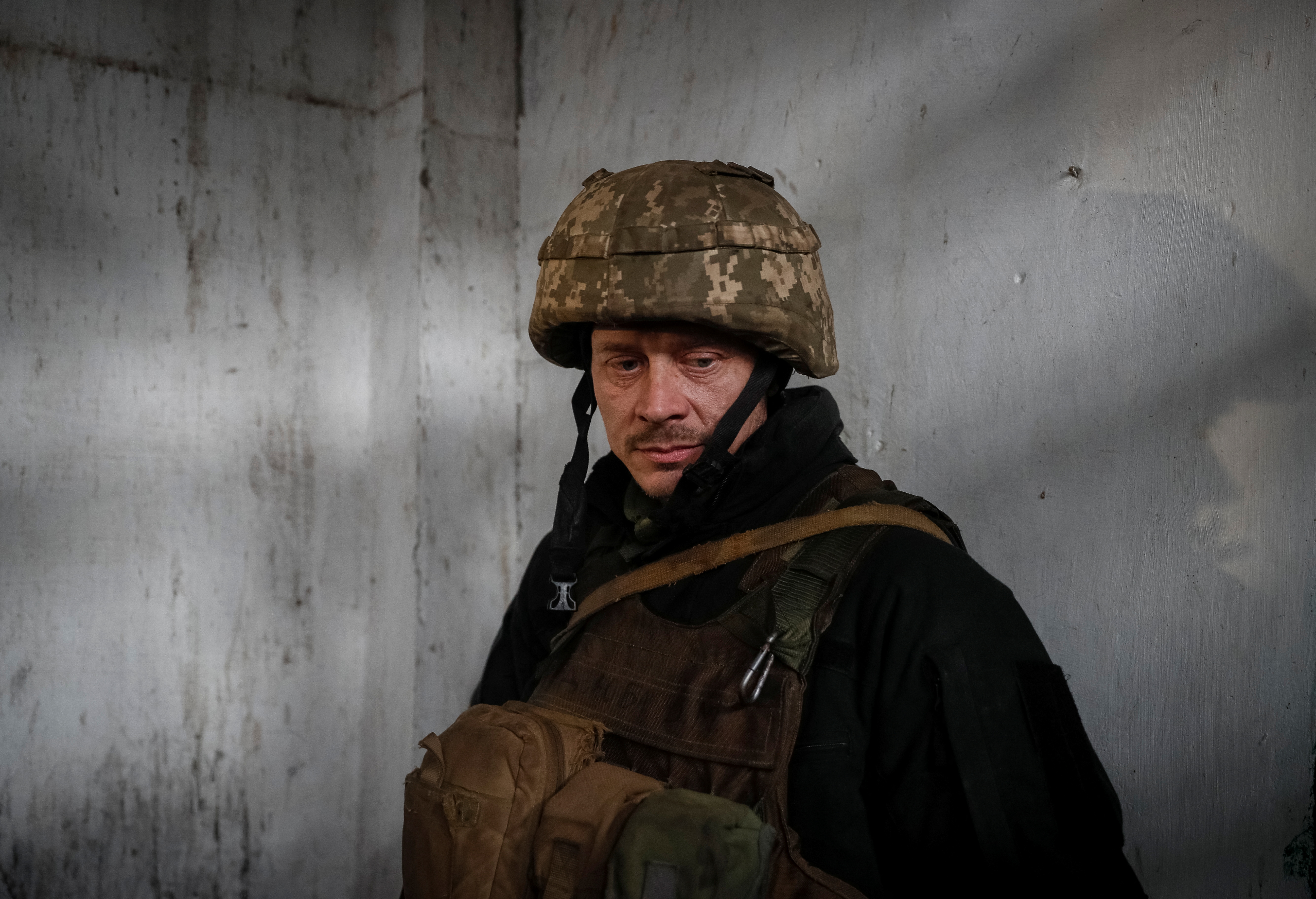 A Ukrainian service member stands in a recessed shelter during a shelling on the front line near the city of Novoluhanske in the Donetsk region, Ukraine February 22, 2022. REUTERS/Gleb Garanich