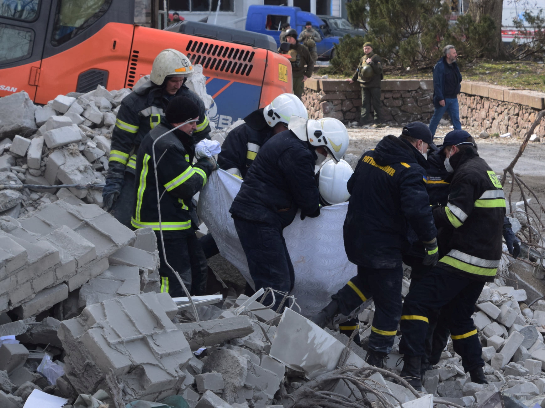 Rescuers evacuate a person from of the regional administration building hit by cruise missiles in Mykolaiv