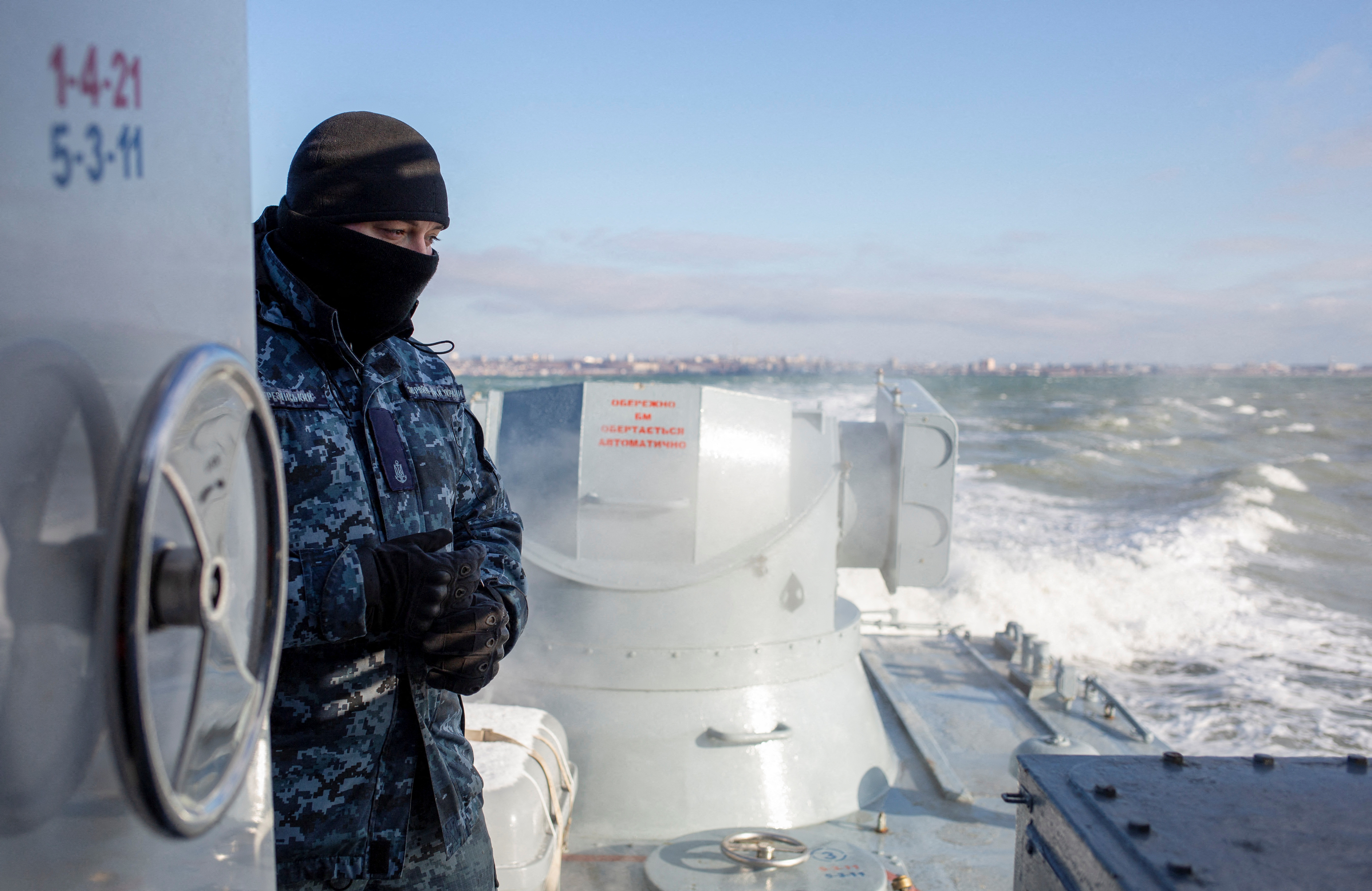 A Ukrainian navy sailor is seen on board an armoured gunboat during a short voyage near a base of the Ukrainian Naval Forces in the Azov Sea port of Berdyansk, Ukraine January 12, 2022. REUTERS/Anastasia Vlasova