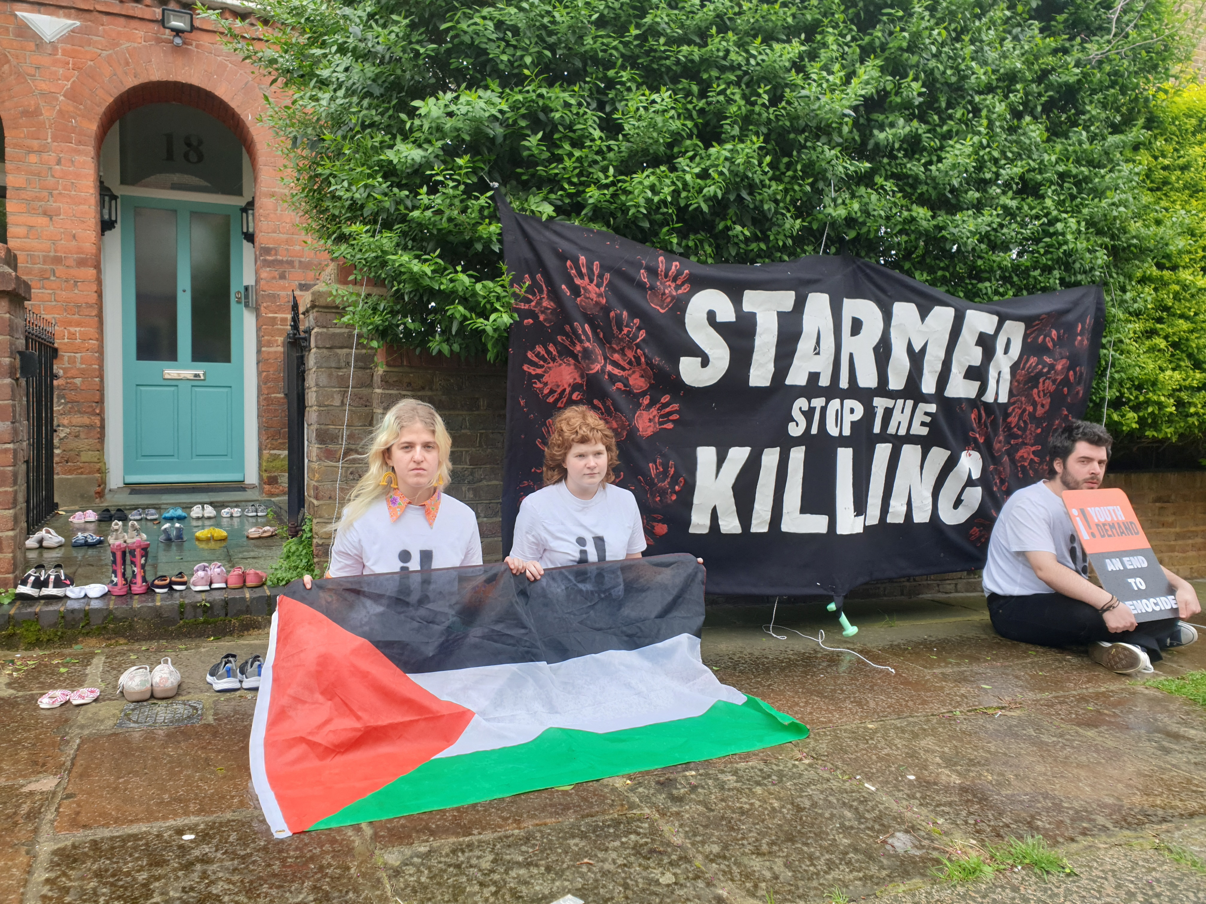 Youth Demand activists sit in front of Labour leader Starmer's London house