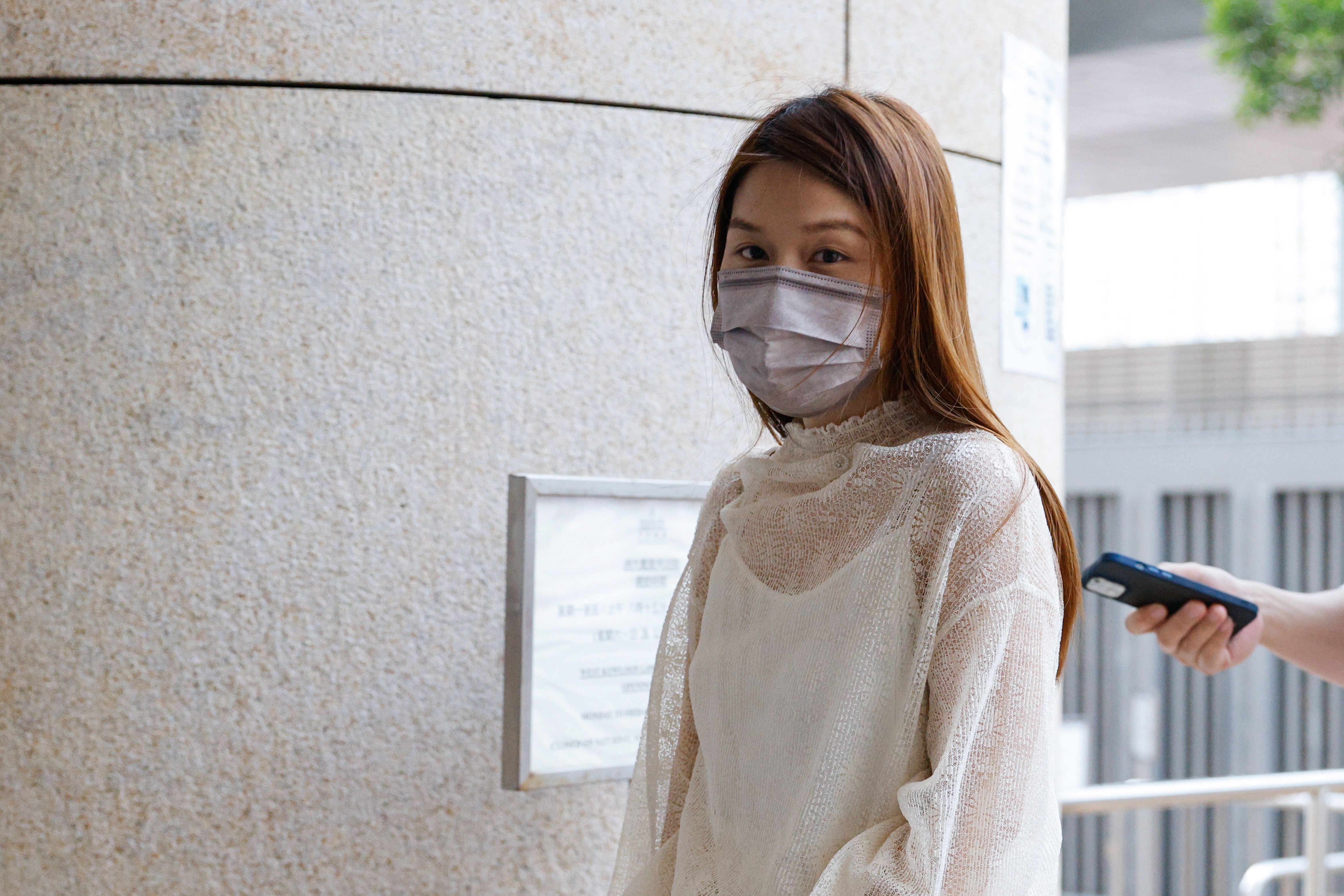 Pro-democracy activist Clarisse Yeung Suet-ying, one of the 47 pro-democracy activists charged with conspiracy to commit subversion under the national security law, arrives West Kowloon Magistrates's Courts building, in Hong Kong