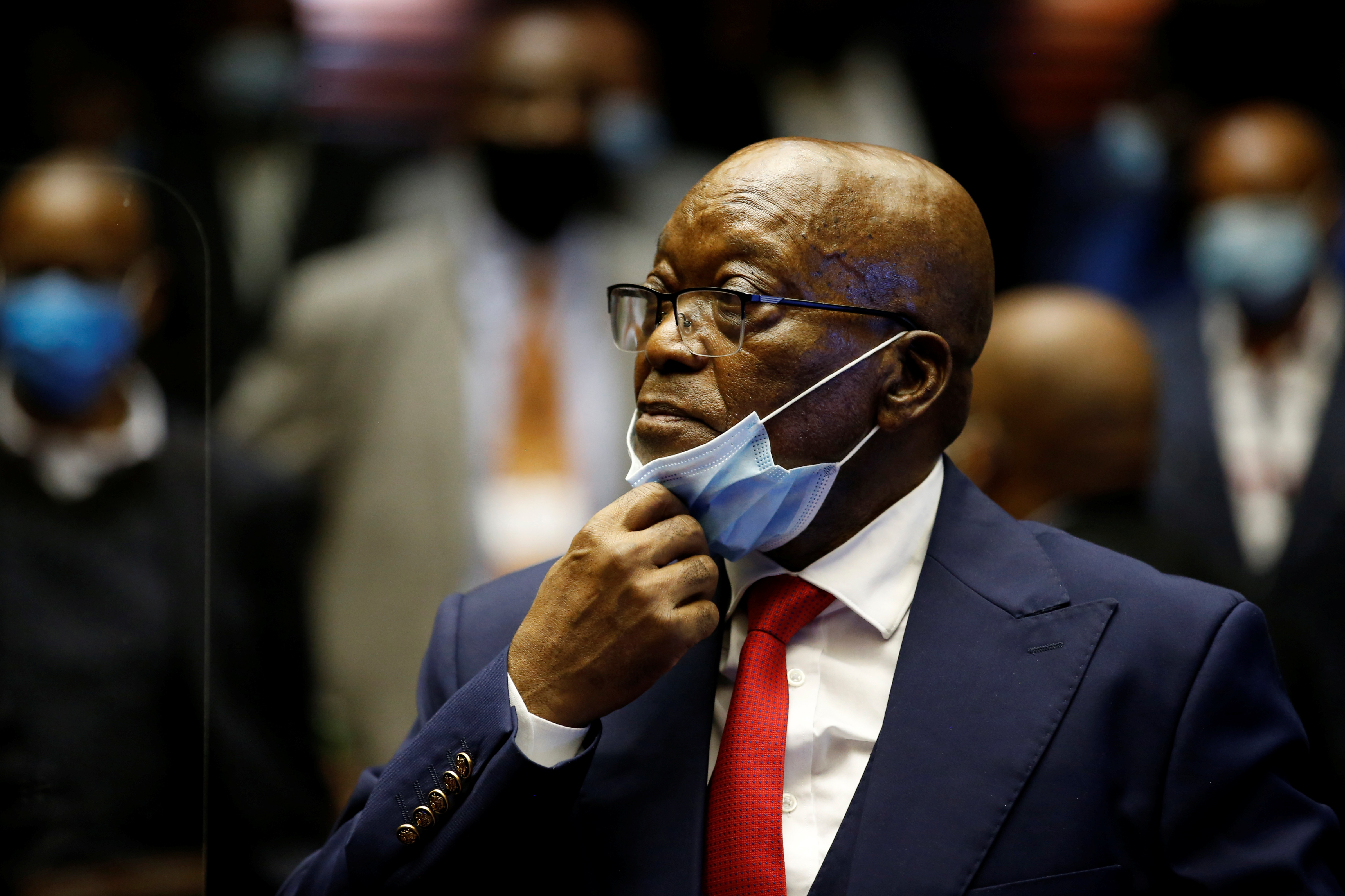Former South African President Jacob Zuma stands in the dock after recess in his corruption trial in Pietermaritzburg