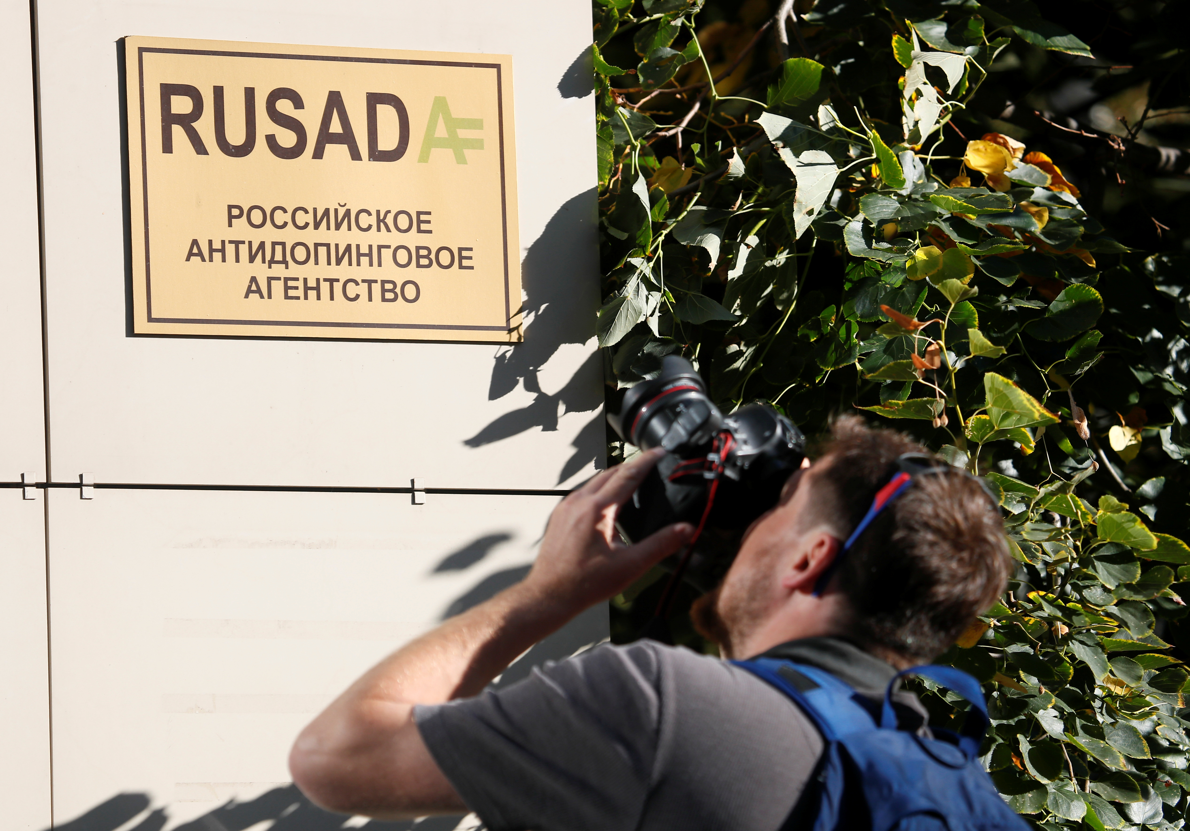 A photographer takes pictures of a sign outside the office of Russian Anti-Doping Agency (RUSADA) in Moscow, Russia September 20, 2018. REUTERS/Maxim Shemetov