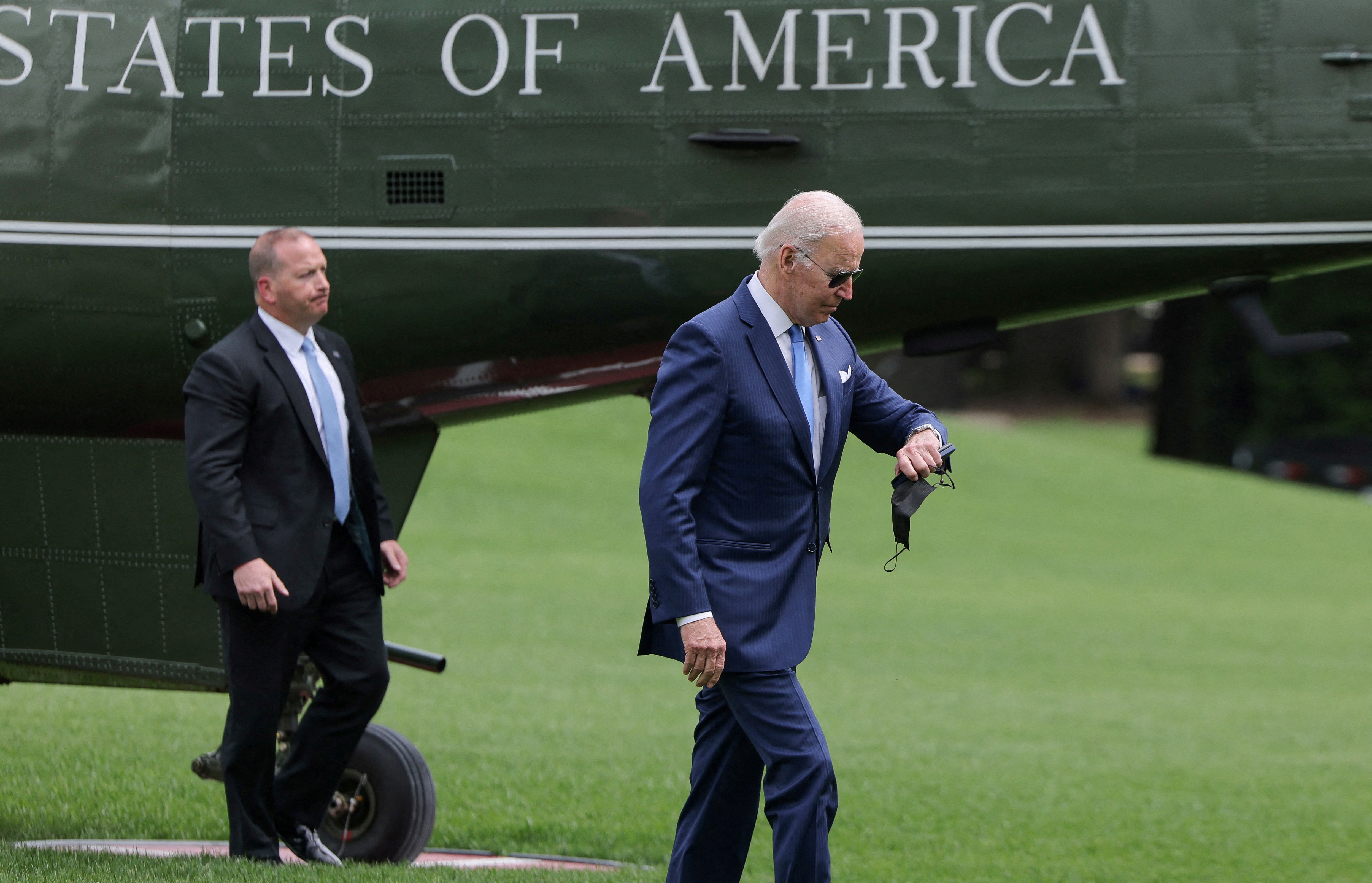 U.S. President Joe Biden checks his watch after arriving at the White House following an interagency briefing on hurricane preparedness at Joint Base Andrews