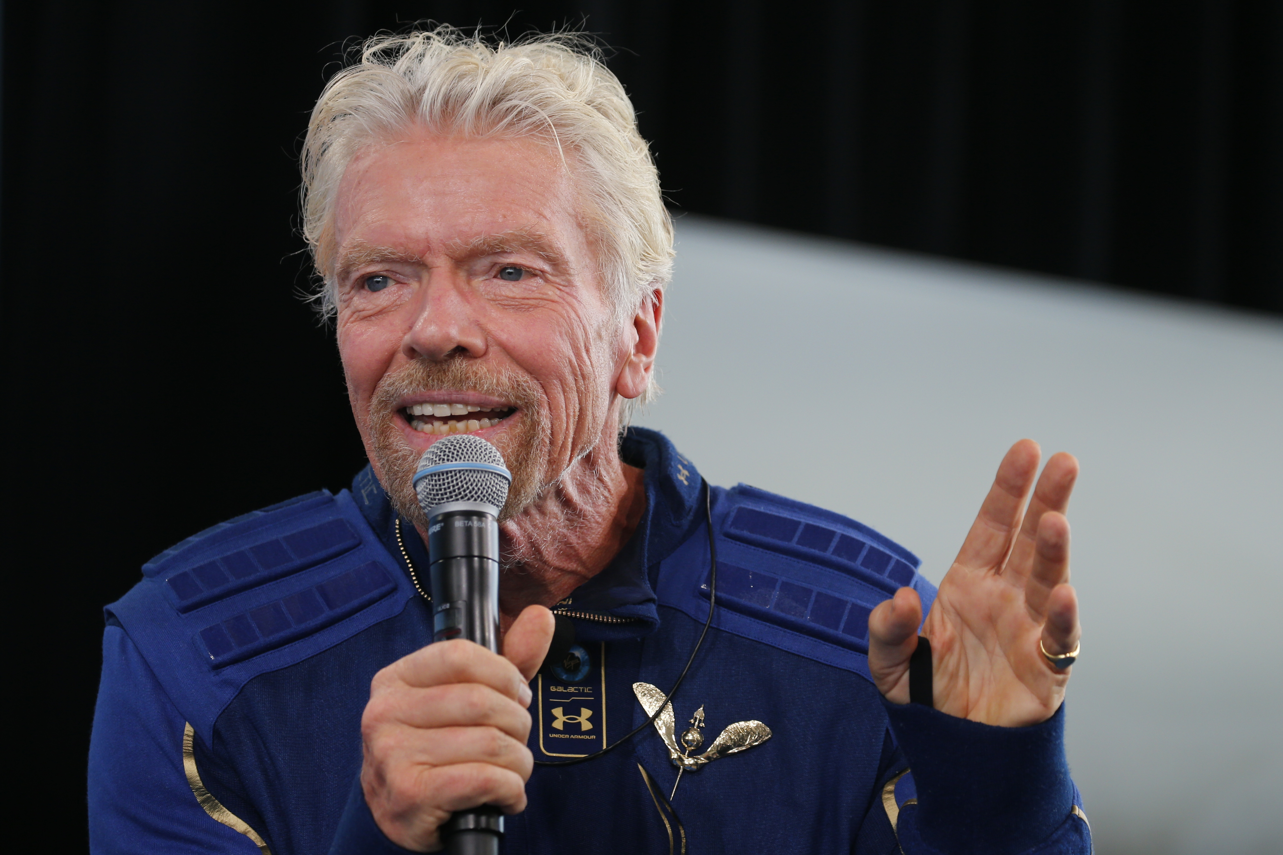 Billionaire entrepreneur Richard Branson wears his astronaut's wings at a news conference at Spaceport America
