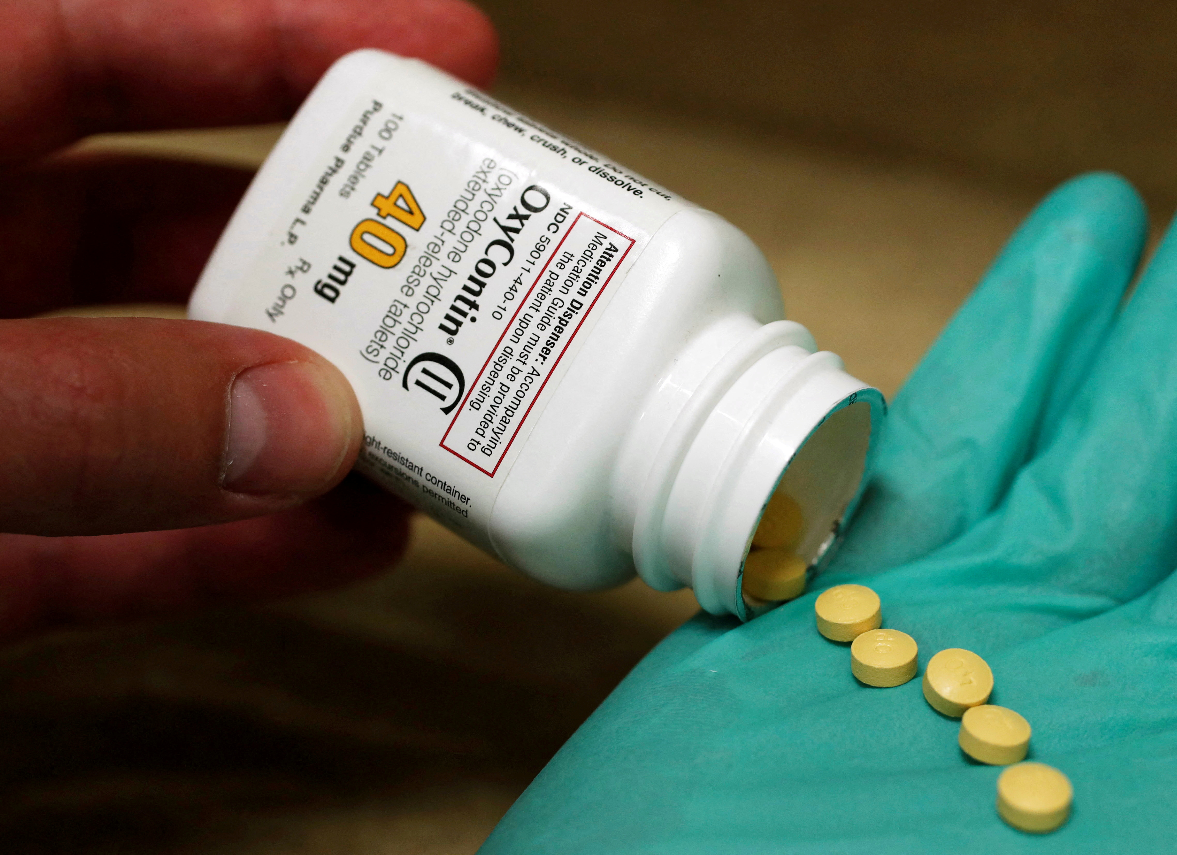 A pharmacist holds prescription painkiller OxyContin at a local pharmacy