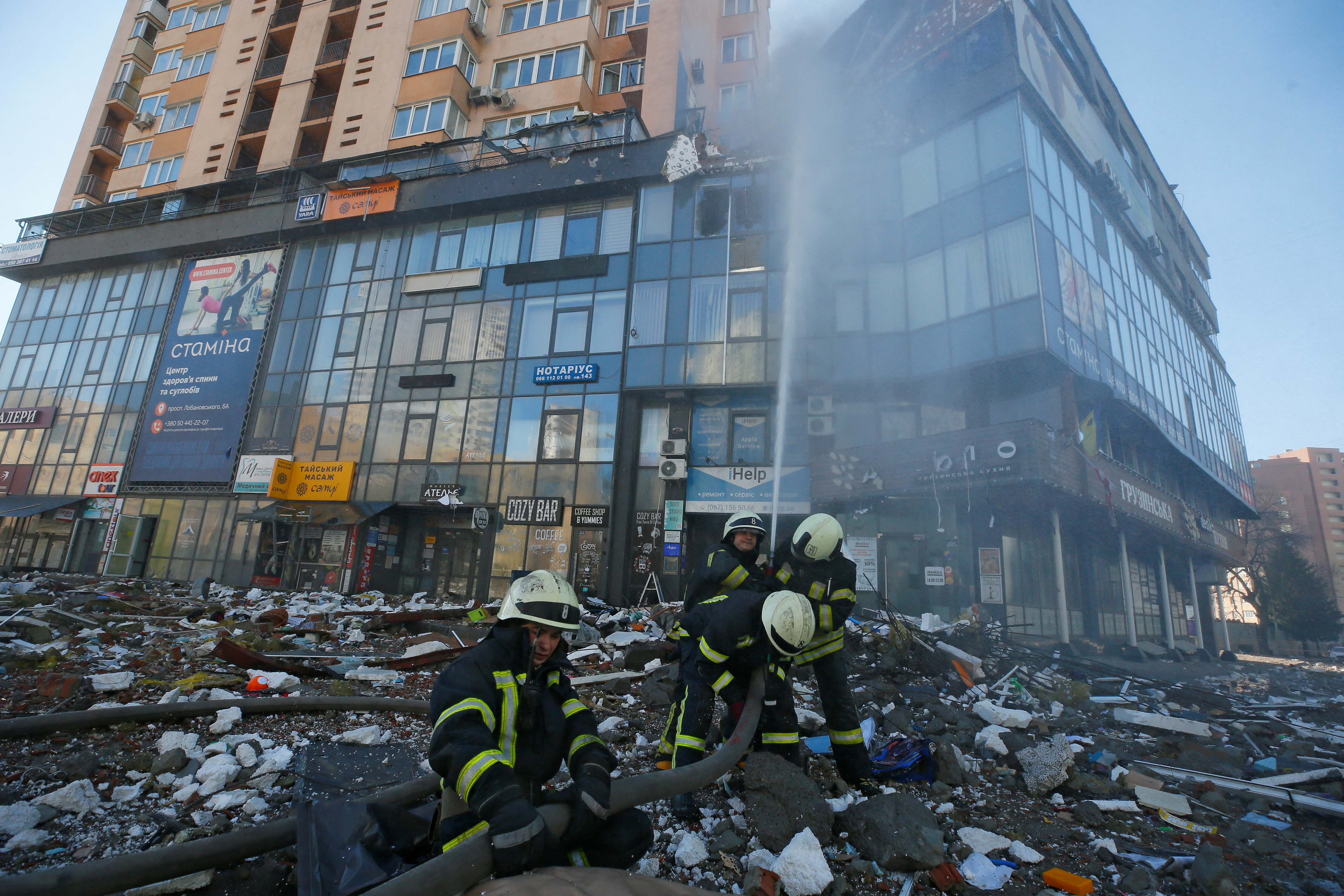 Firefighters extinguish fire in an apartment building damaged by recent shelling in Kyiv, Ukraine February 26, 2022. REUTERS/Gleb Garanich
