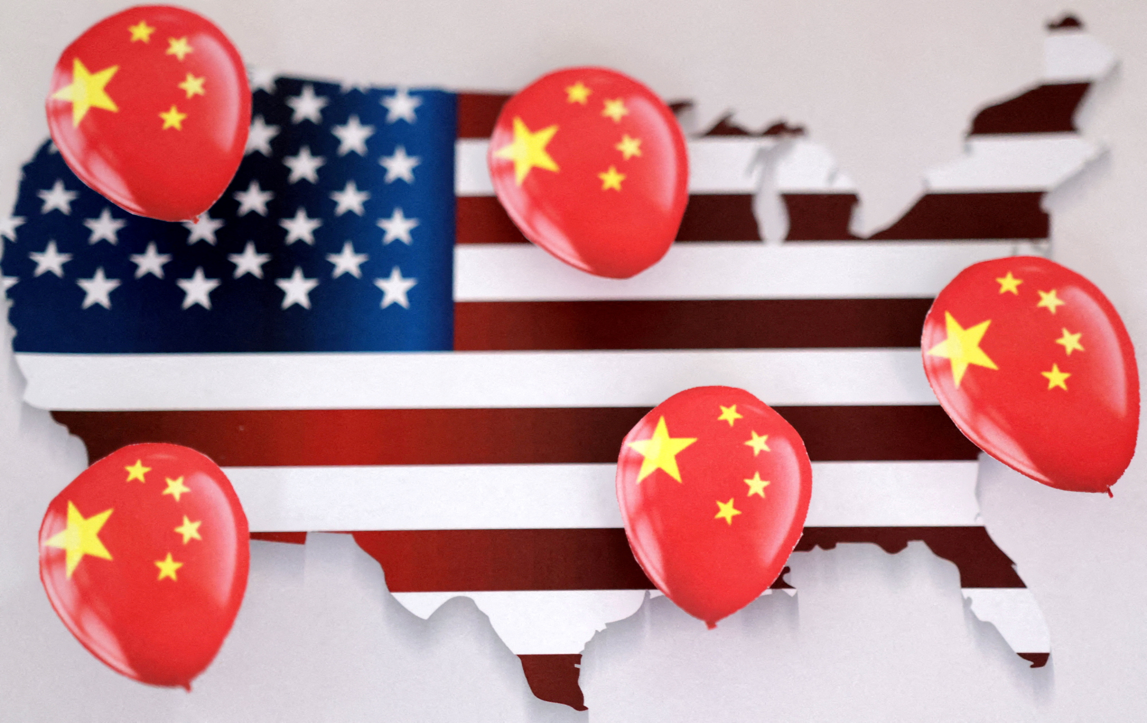 Illustration shows printed balloons with Chinese flag and U.S. map outline
