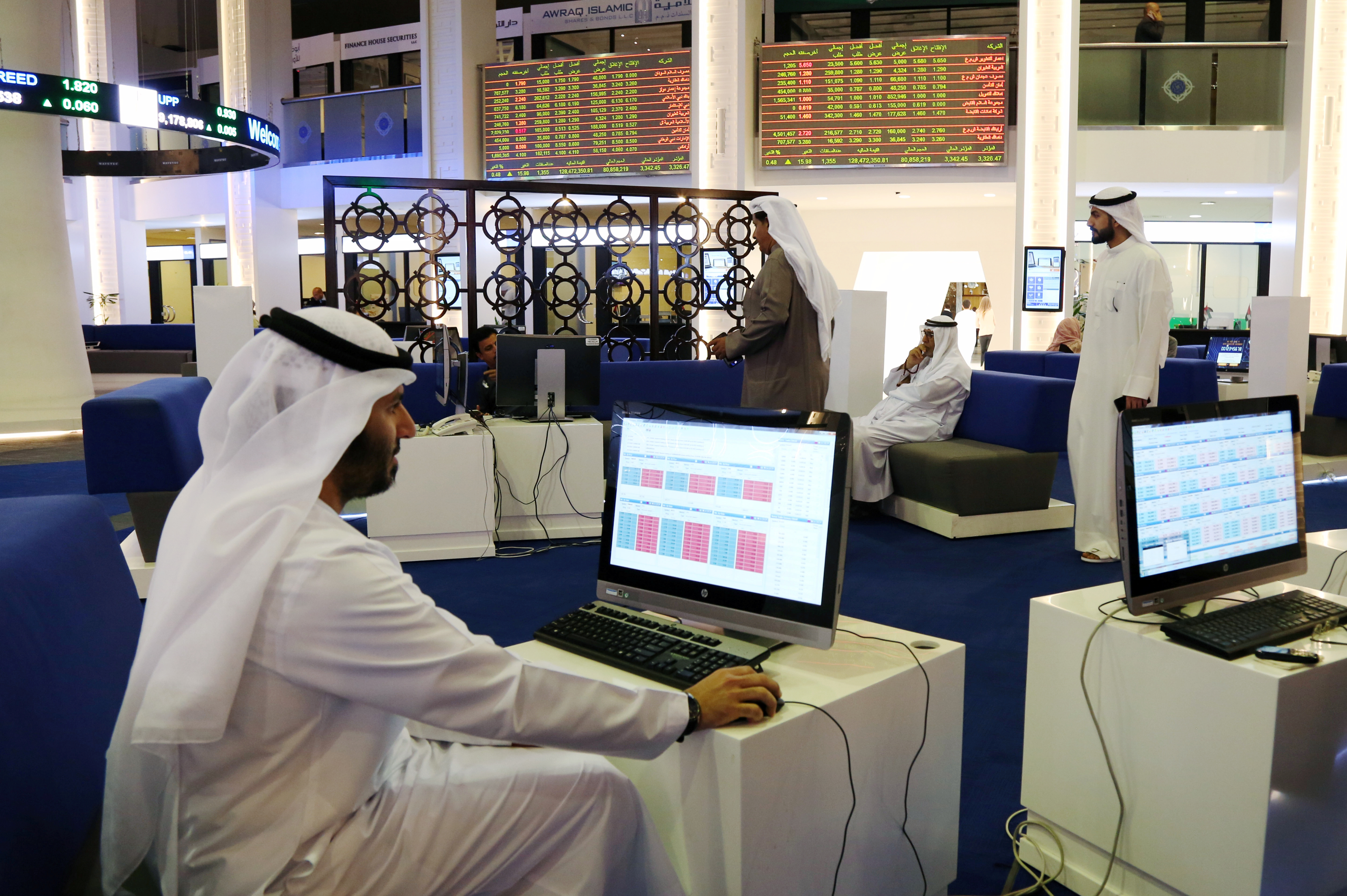 Investors are seen at the Dubai International Financial Market in Dubai.