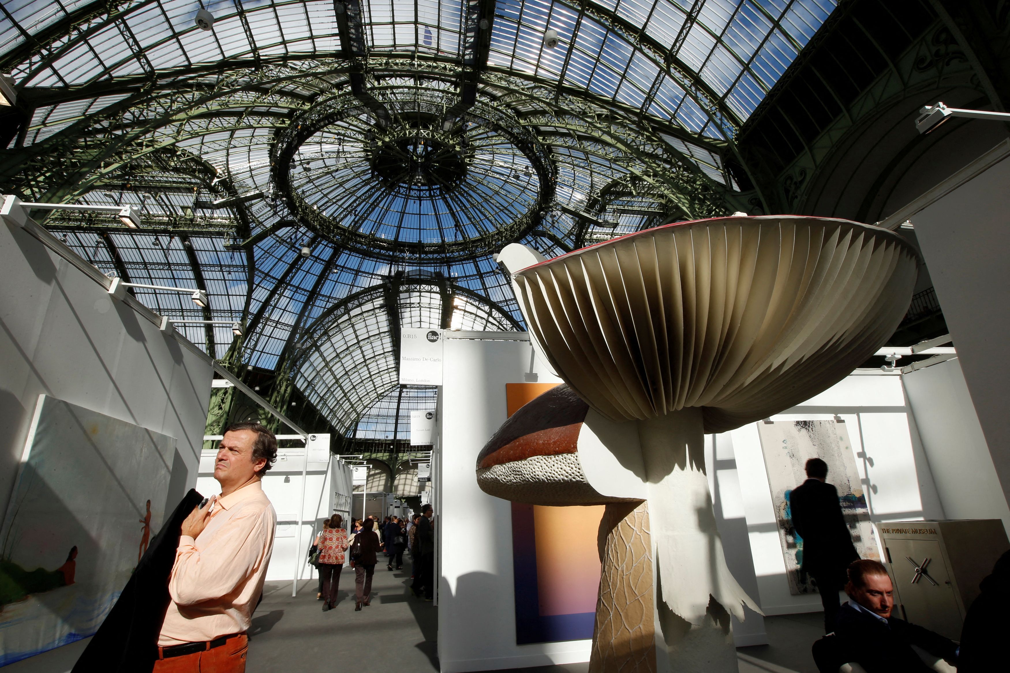 A visitor walks past art works by artist Carsten Holler during the International Contemporary Art Fair at the Grand Palais in Paris