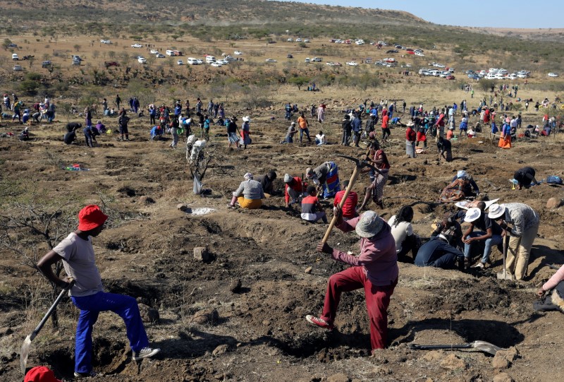 A man uses a pickaxe to dig as fortune seekers flock to the village of KwaHlathi outside Ladysmith