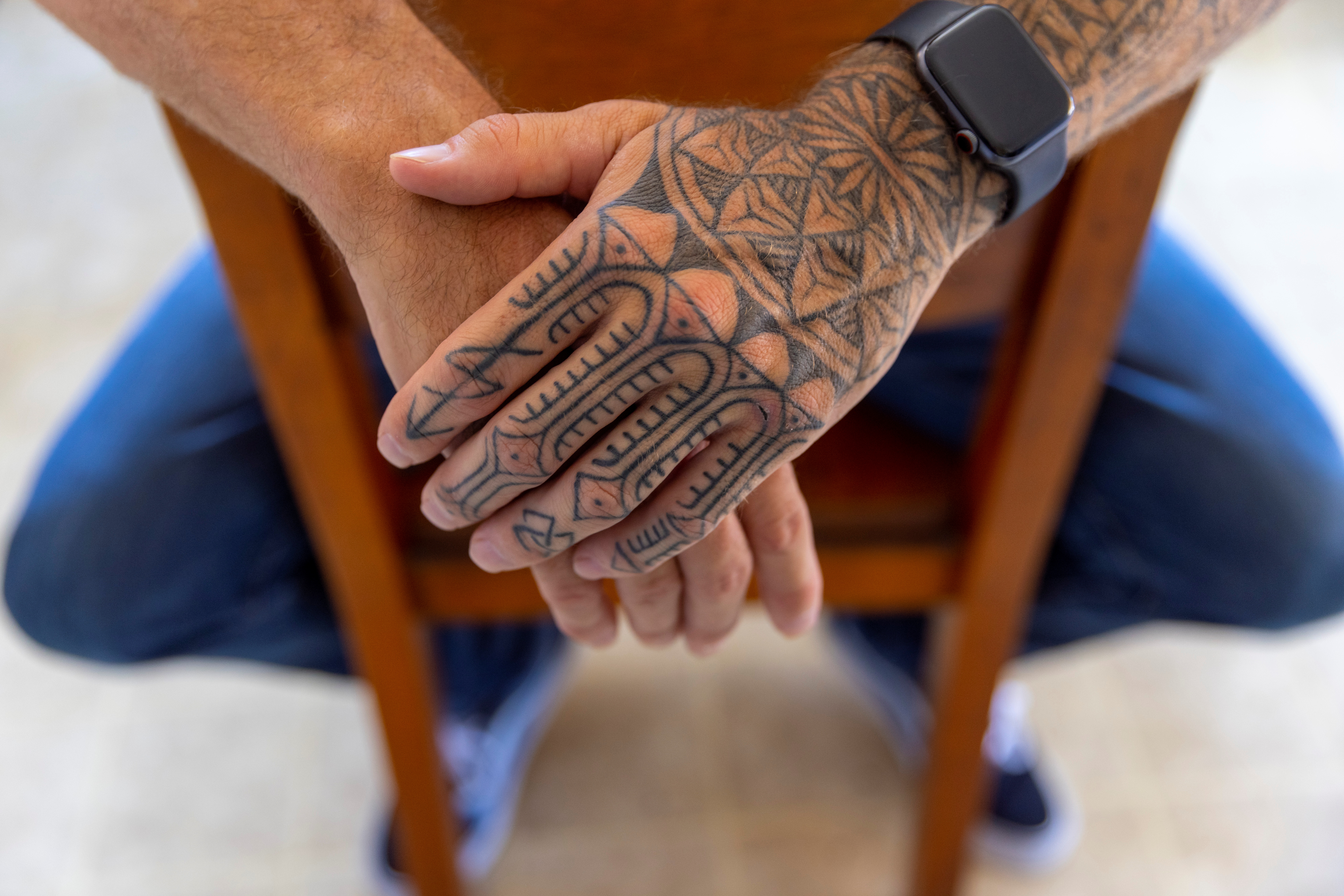 Tattoos are shown on the arm U.S special forces veteran Jason Lilley as he poses for a portrait at his home in Garden Grove, California, U.S.,  July 9, 2021. Lilley spoke to Reuters about his experience in Afghanistan and his thoughts as the U.S. leaves the country.  Picture taken July 9, 202.   REUTERS/Mike Blake