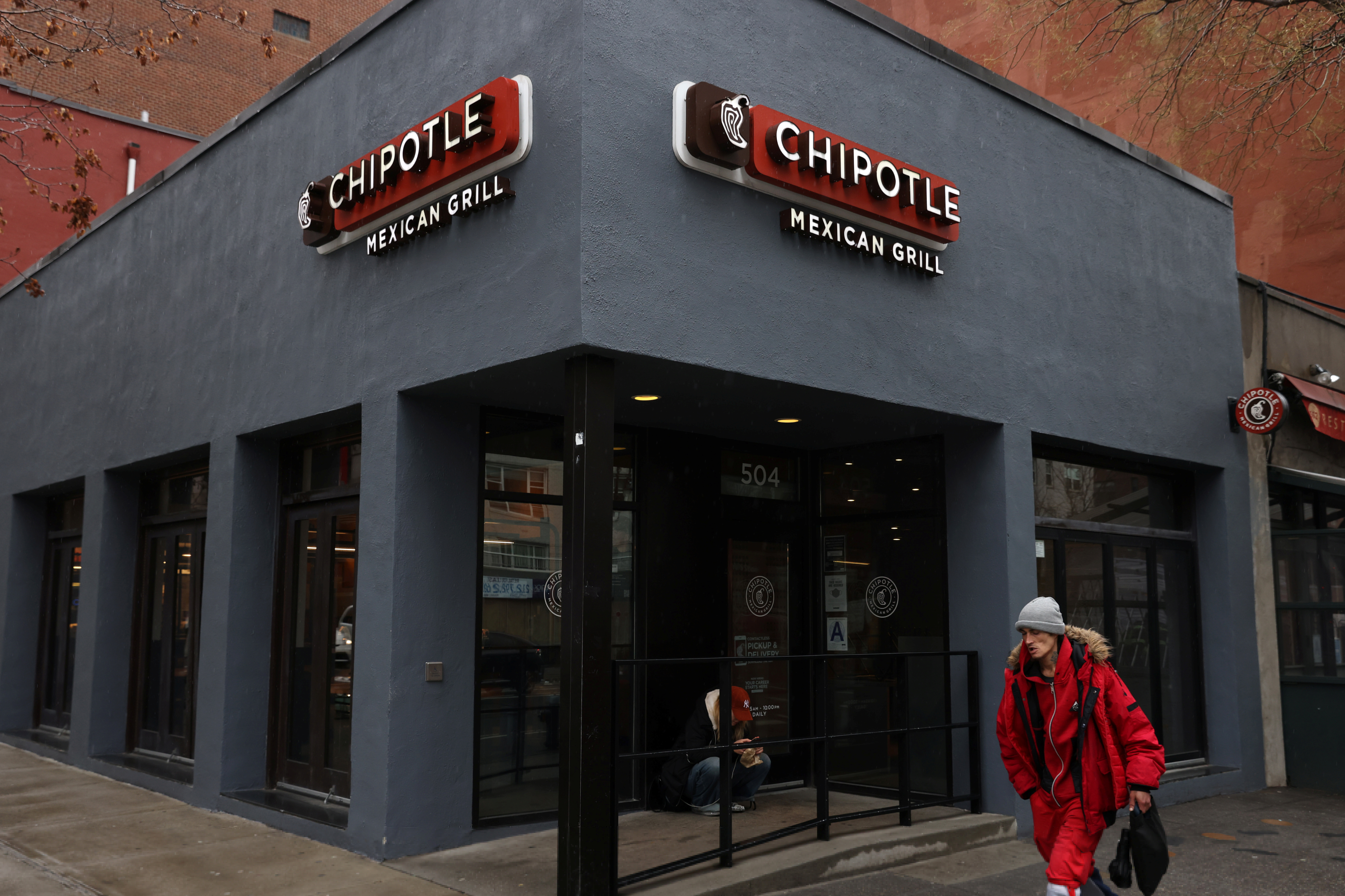 A person walks by a Chipotle in Manhattan, New York City