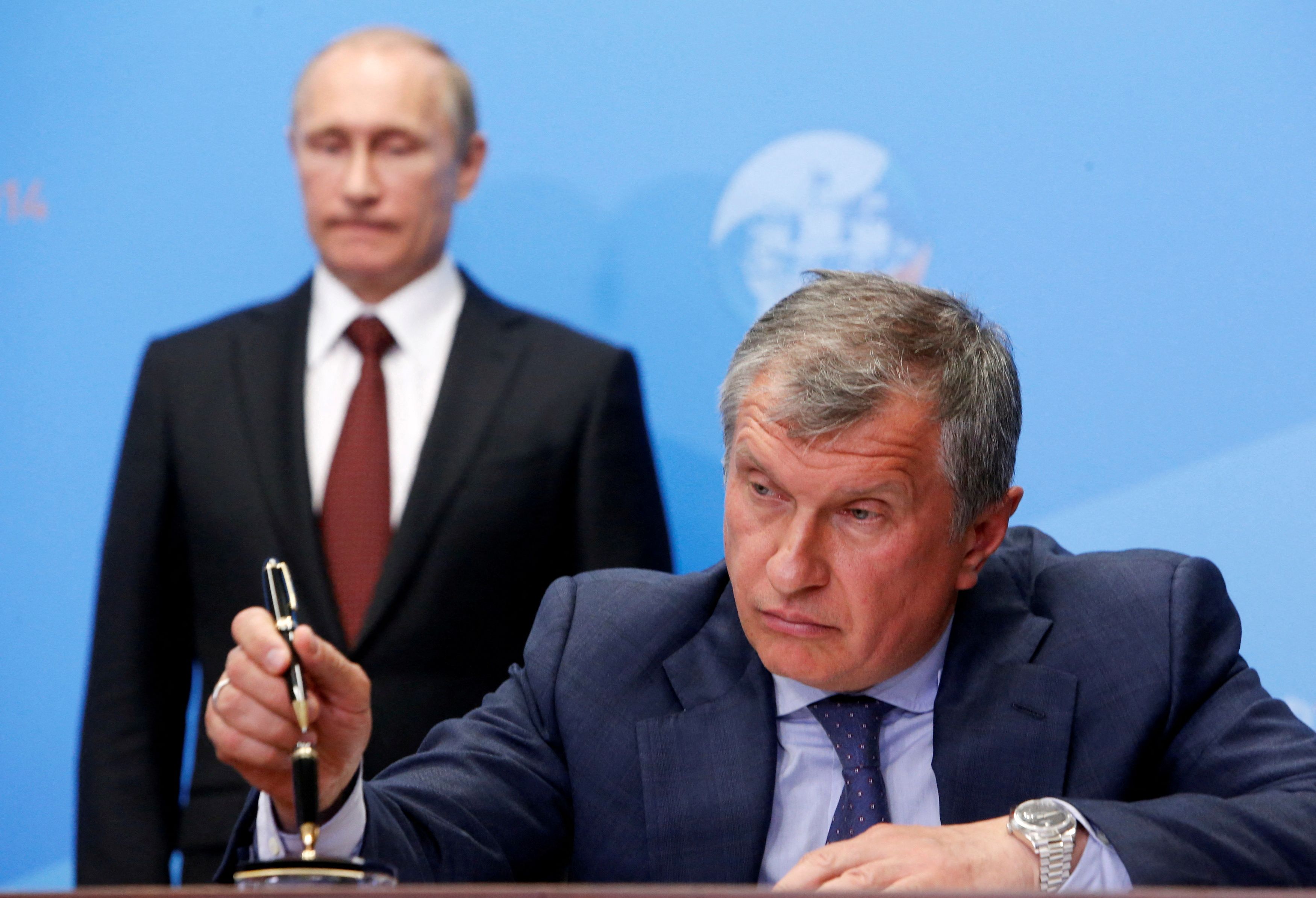 Russia's President Putin and Rosneft CEO Igor Sechin attend a signing ceremony at the St. Petersburg International Economic Forum 2014 in St. Petersburg