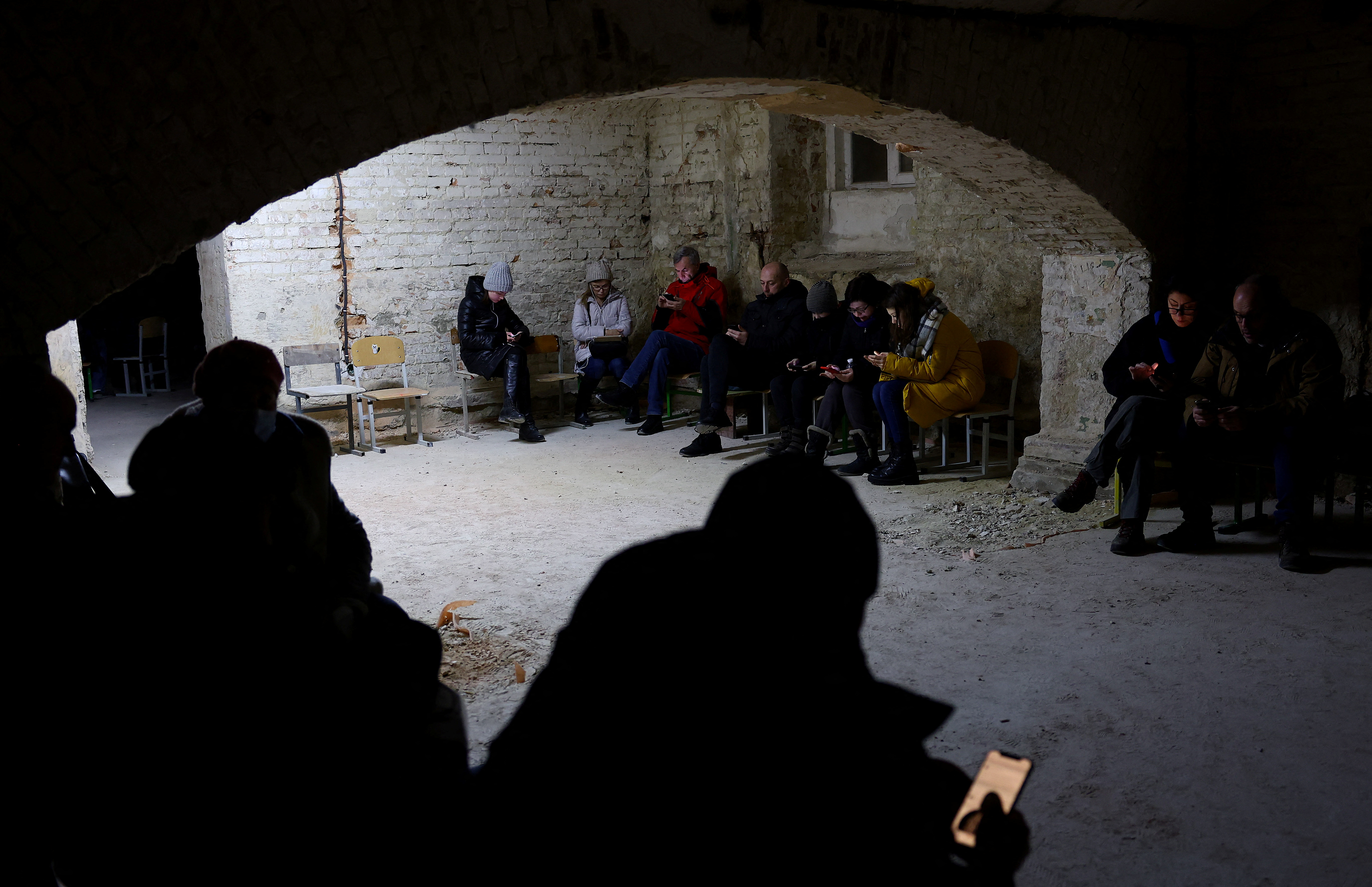 People takle shelter in the basement of a school in Lviv