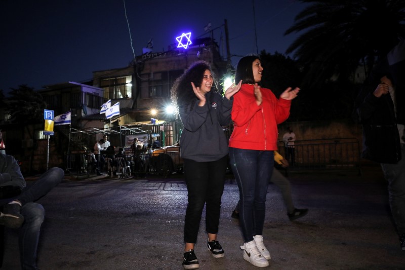 Tala, a member of the Abu Diab family, Palestinian residents of Sheikh Jarrah, reacts with a friend in her neighbourhood in East Jerusalem