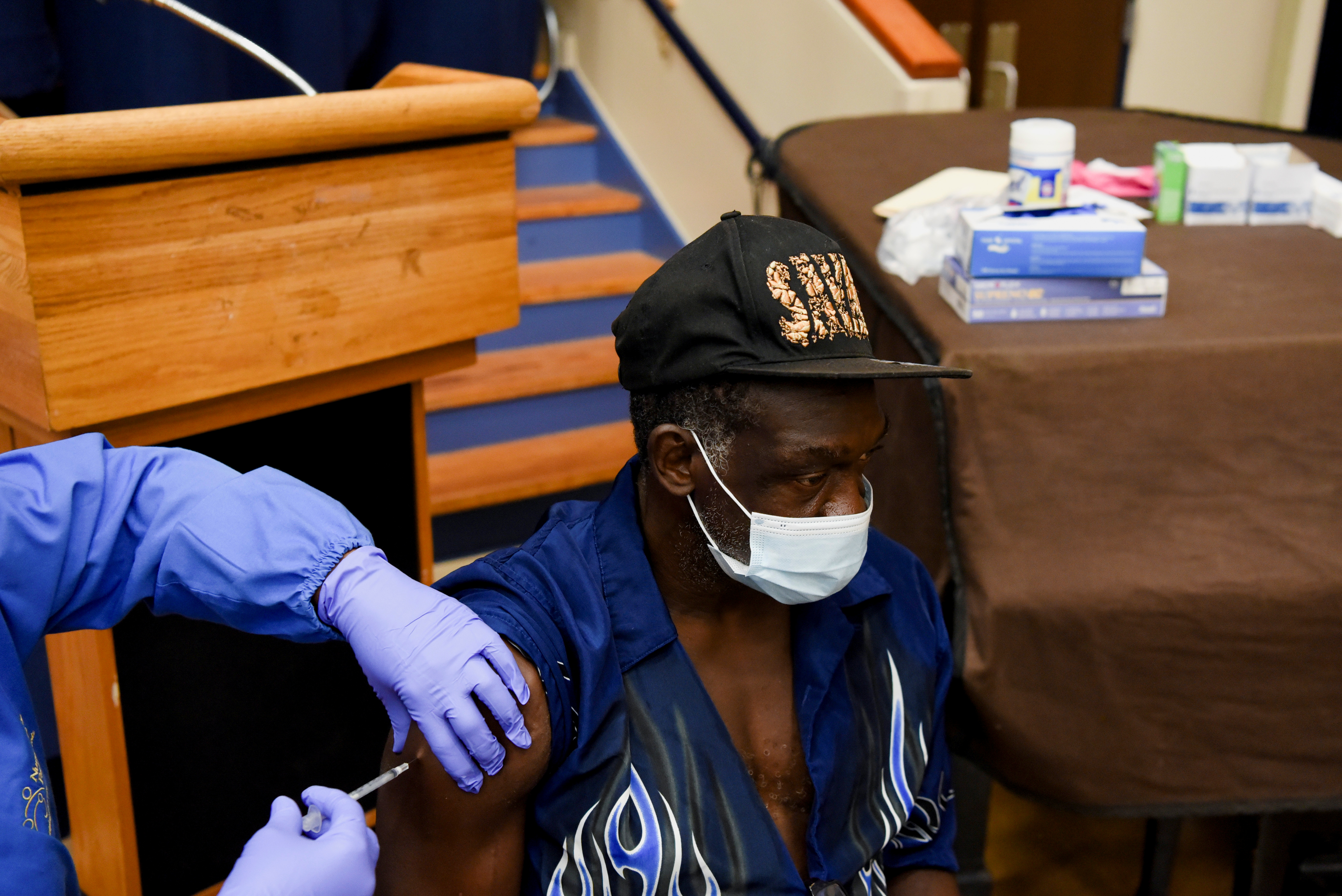 A person receives a vaccine for the coronavirus disease (COVID-19) following Republican Governor Greg Abbott's ban on COVID-19 vaccine mandates by any entity, including private employers, at Acres Home Multi-Service Center in Houston, Texas, U.S., October 13, 2021.  REUTERS/Callaghan O'Hare