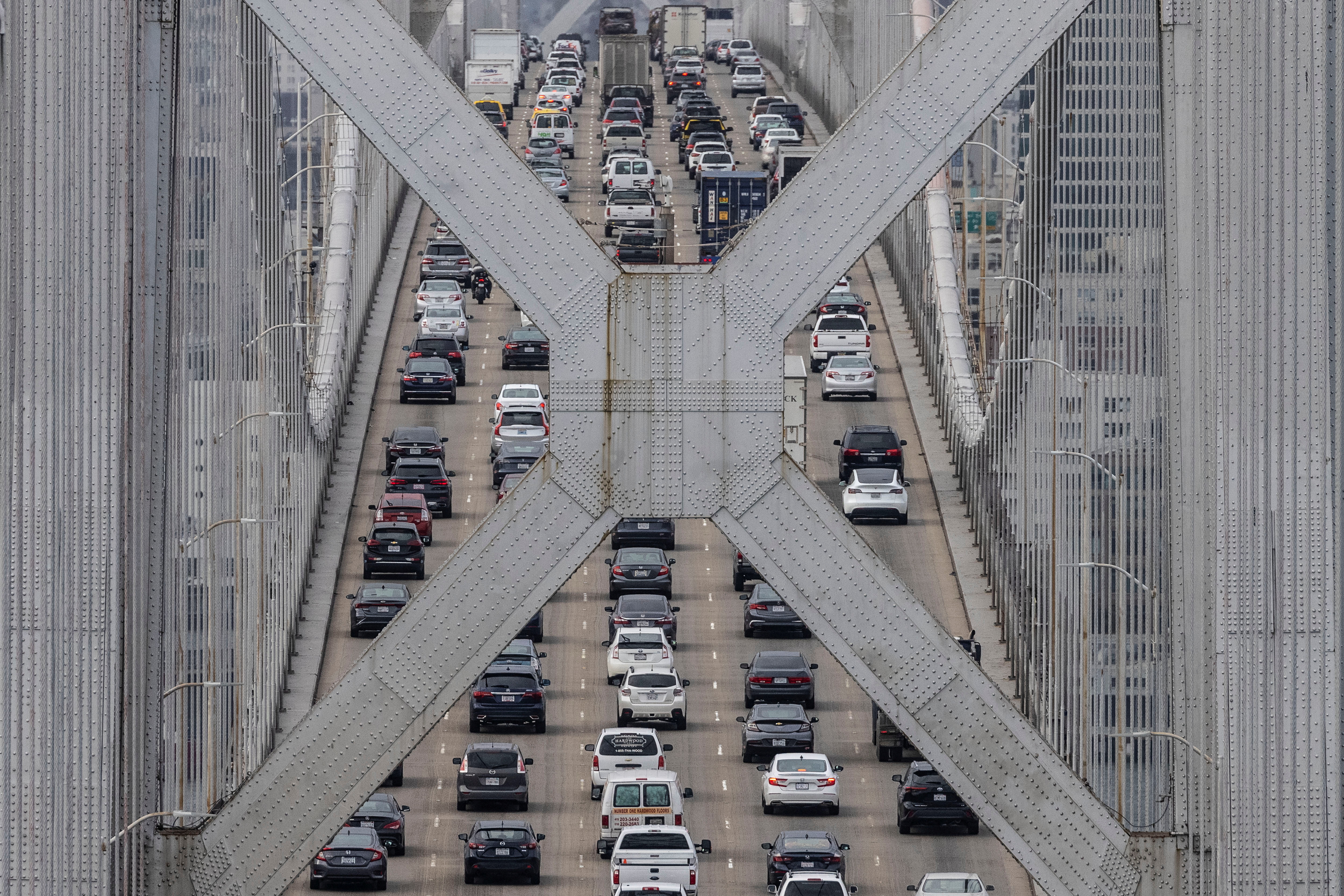 Vehicles drive across the San Francisco – Oakland Bay Bridge in San Francisco, California