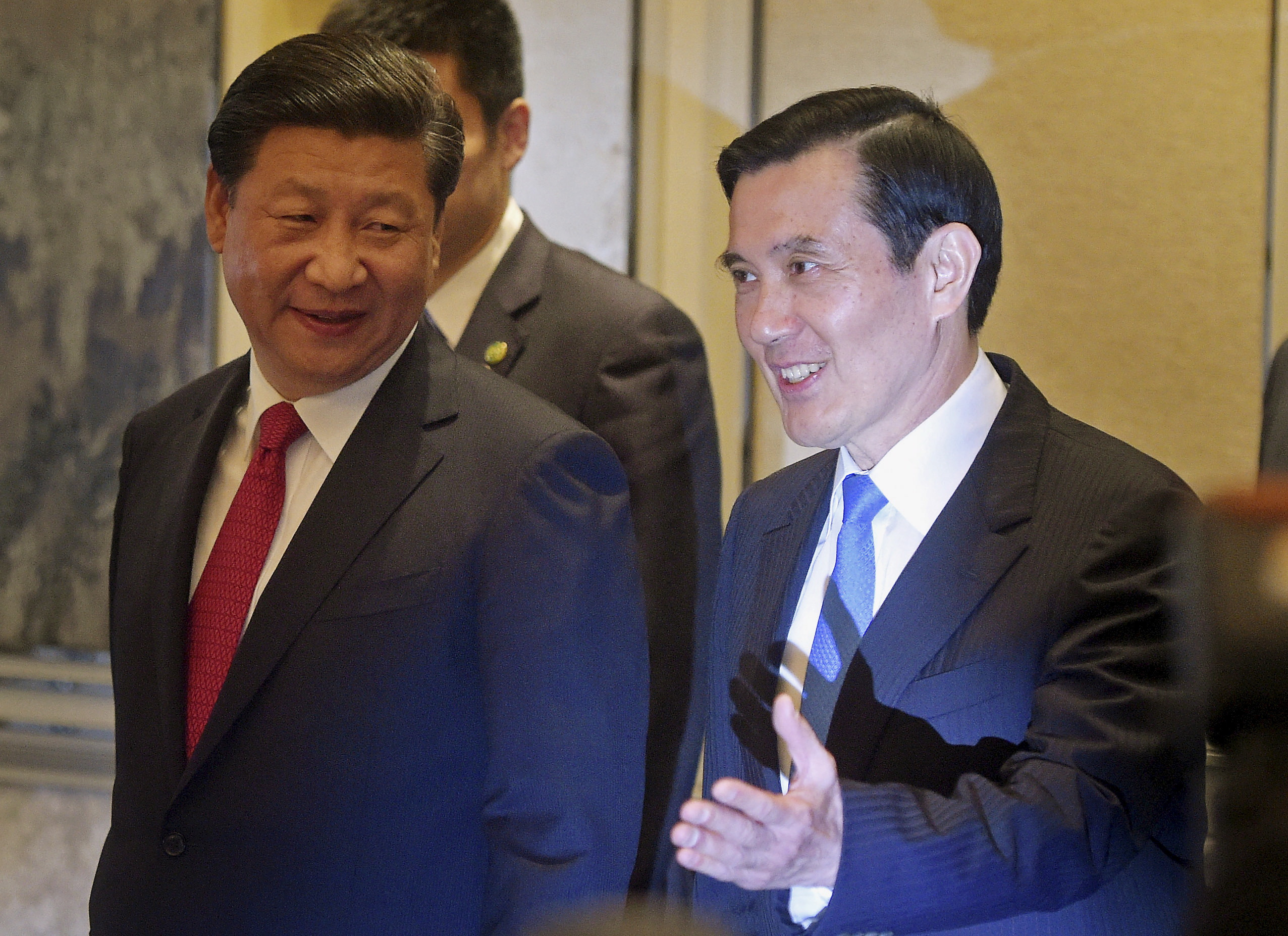 Chinese President Xi Jinping and Taiwanese President Ma Ying-jeou smile as they enter the room at the Shangri-la Hotel where they are to meet, in Singapore