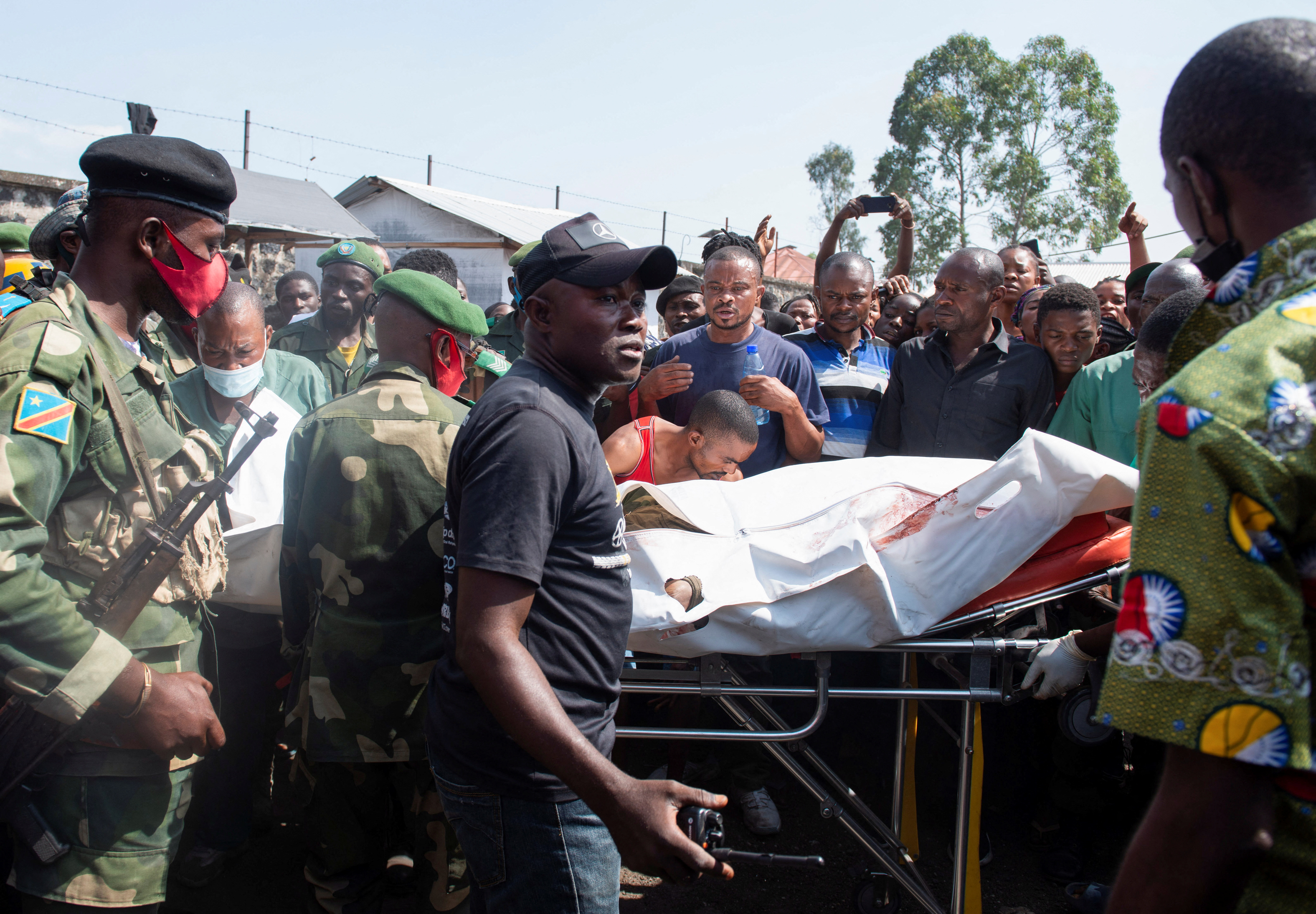 Congolese soldiers and civilians receive the body of a Congolese soldier shot dead in Rwanda