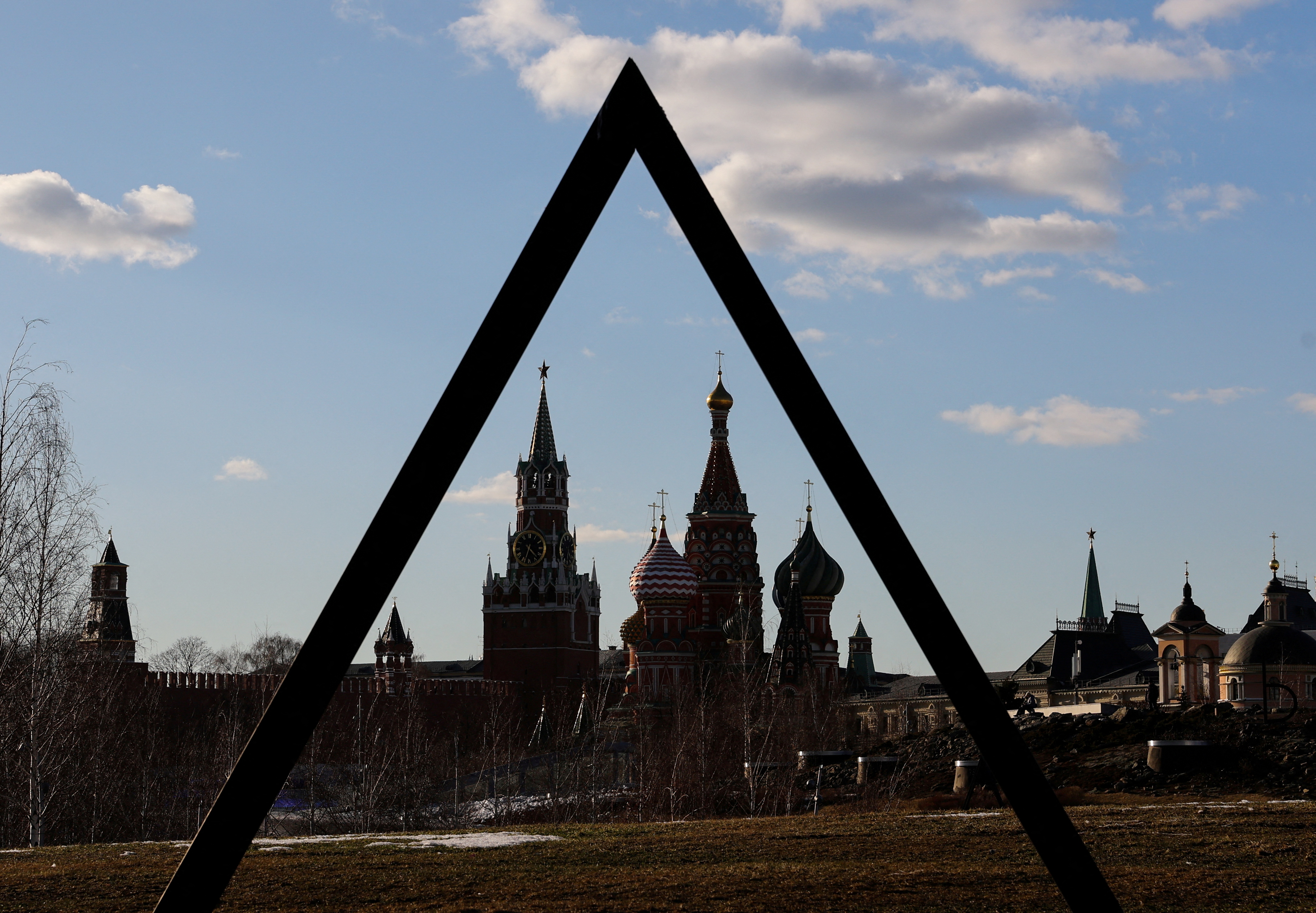 The Kremlin's Spasskaya Tower and St. Basil's Cathedral are seen through the art object in Zaryadye park in Moscow