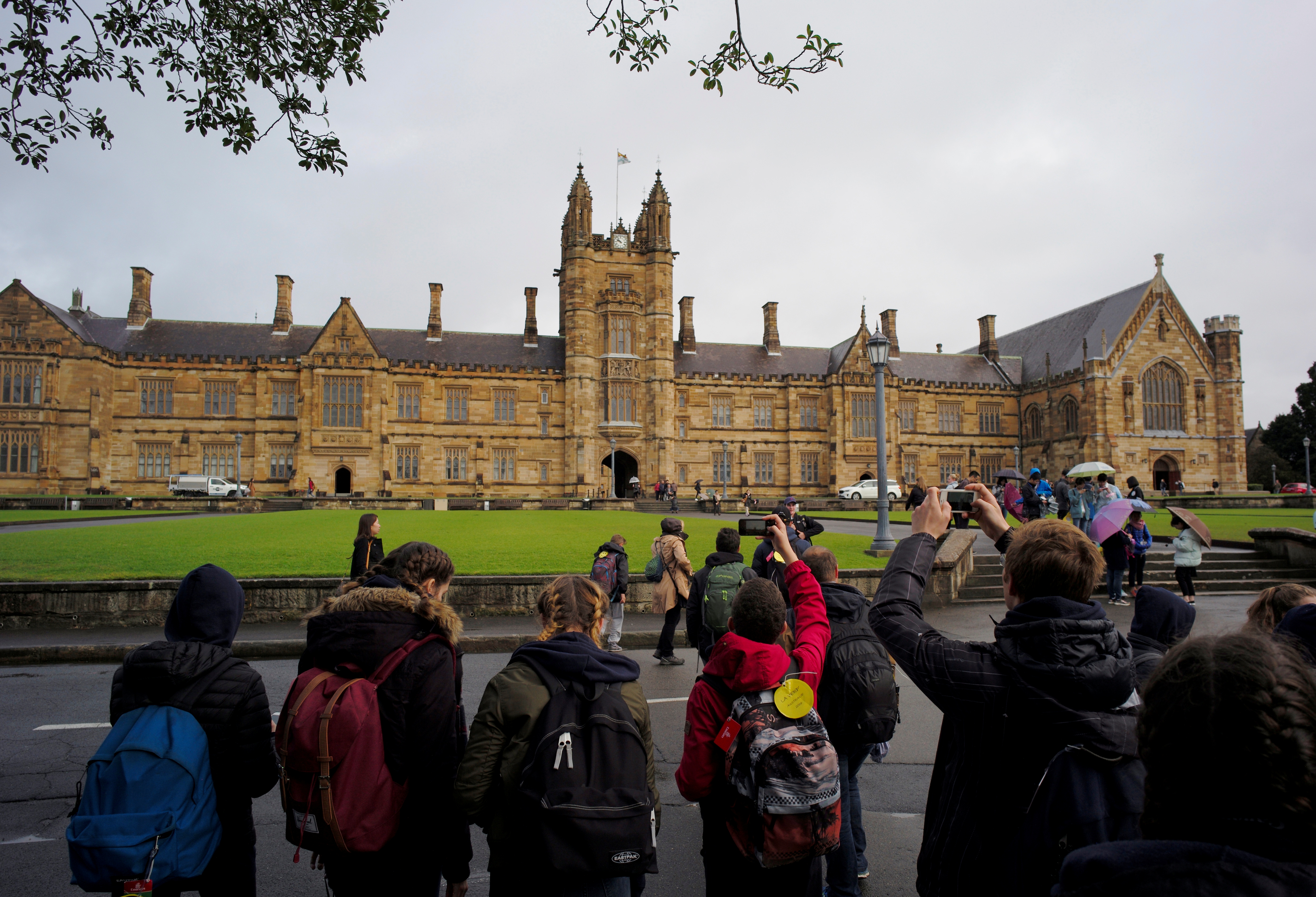 Visitors take pictures of the main building at the University of Sydney in Australia