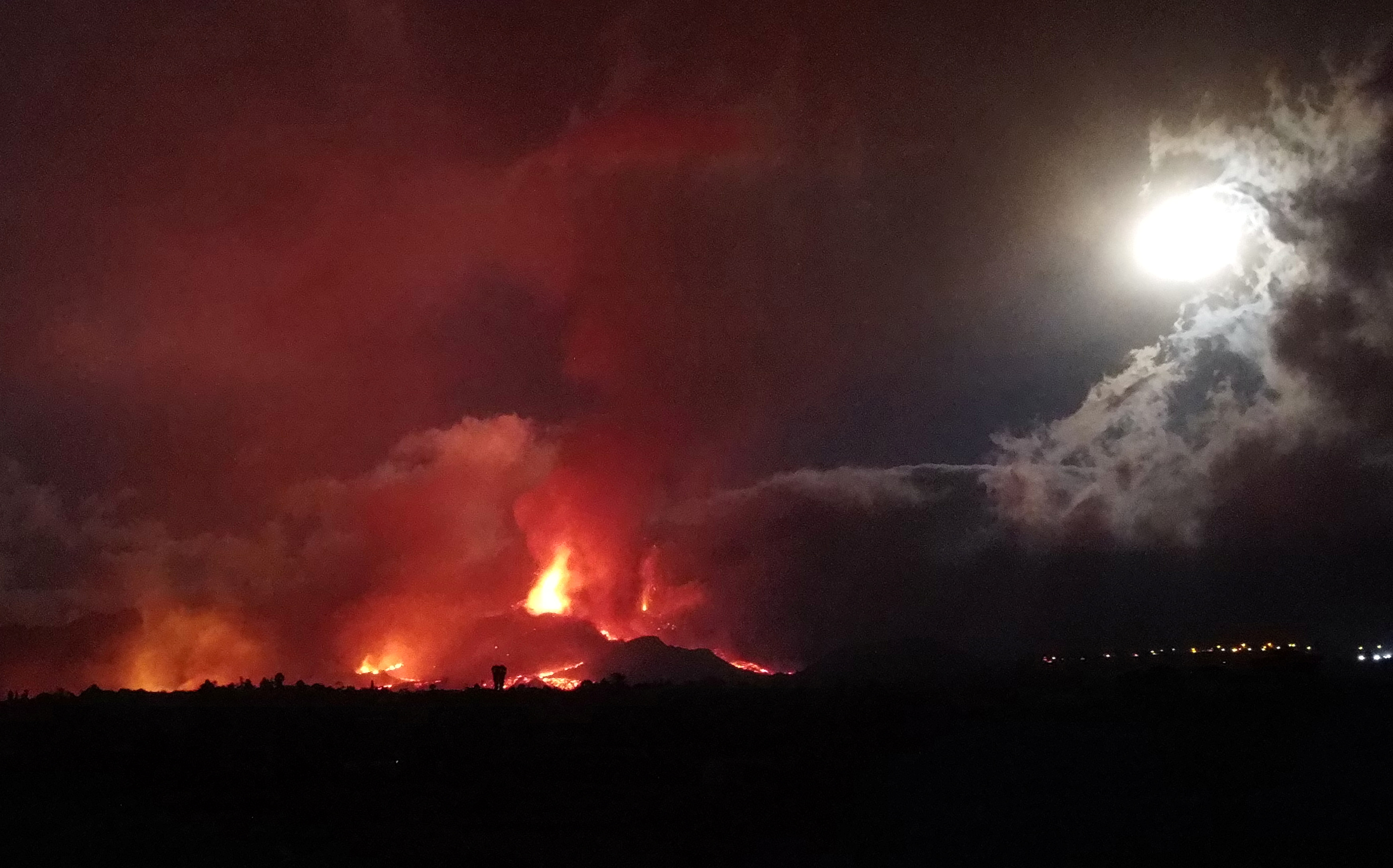 Lava and smoke rise following the eruption of a volcano on the Island of La Palma