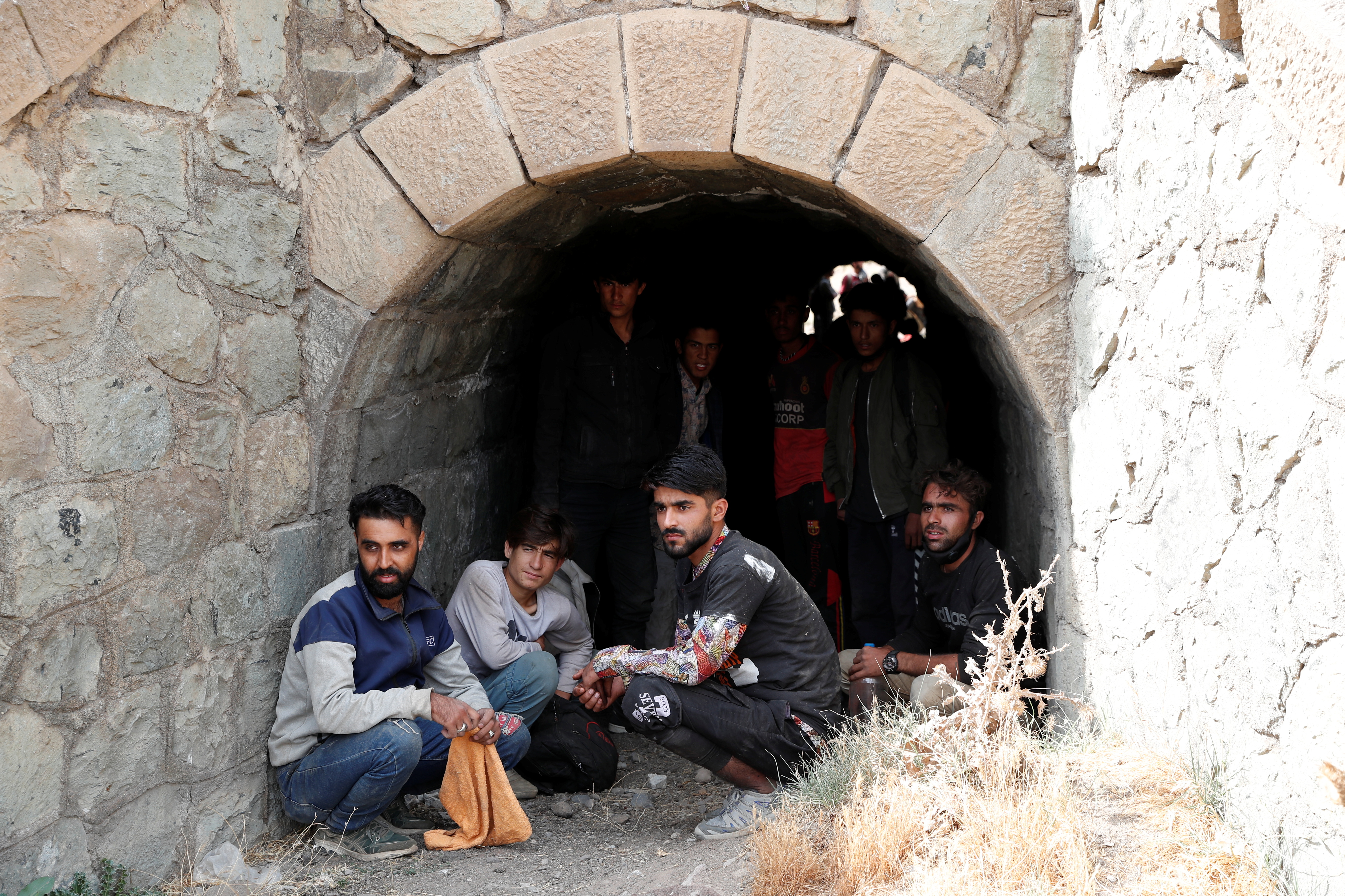 Afghan migrants hide from security forces in a tunnel under train tracks after crossing illegally into Turkey from Iran, near Tatvan in Bitlis province, Turkey August 23, 2021. Picture taken August 23, 2021. REUTERS/Murad Sezer