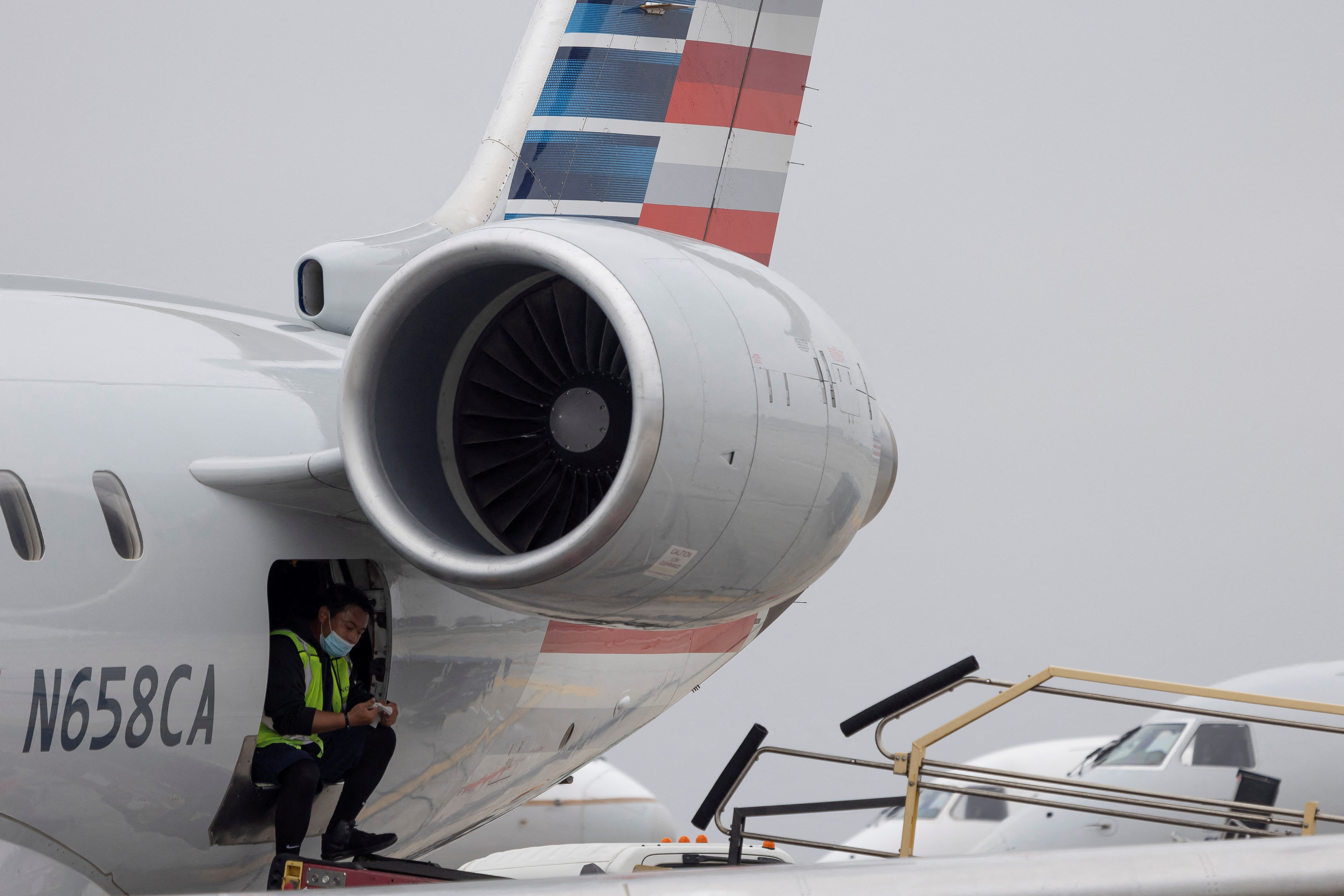 An American Airlines worker is seen as more than 1,400 American airlines have been canceled due to staff shortages and unfavorable weather in Los Angeles, California, U.S.