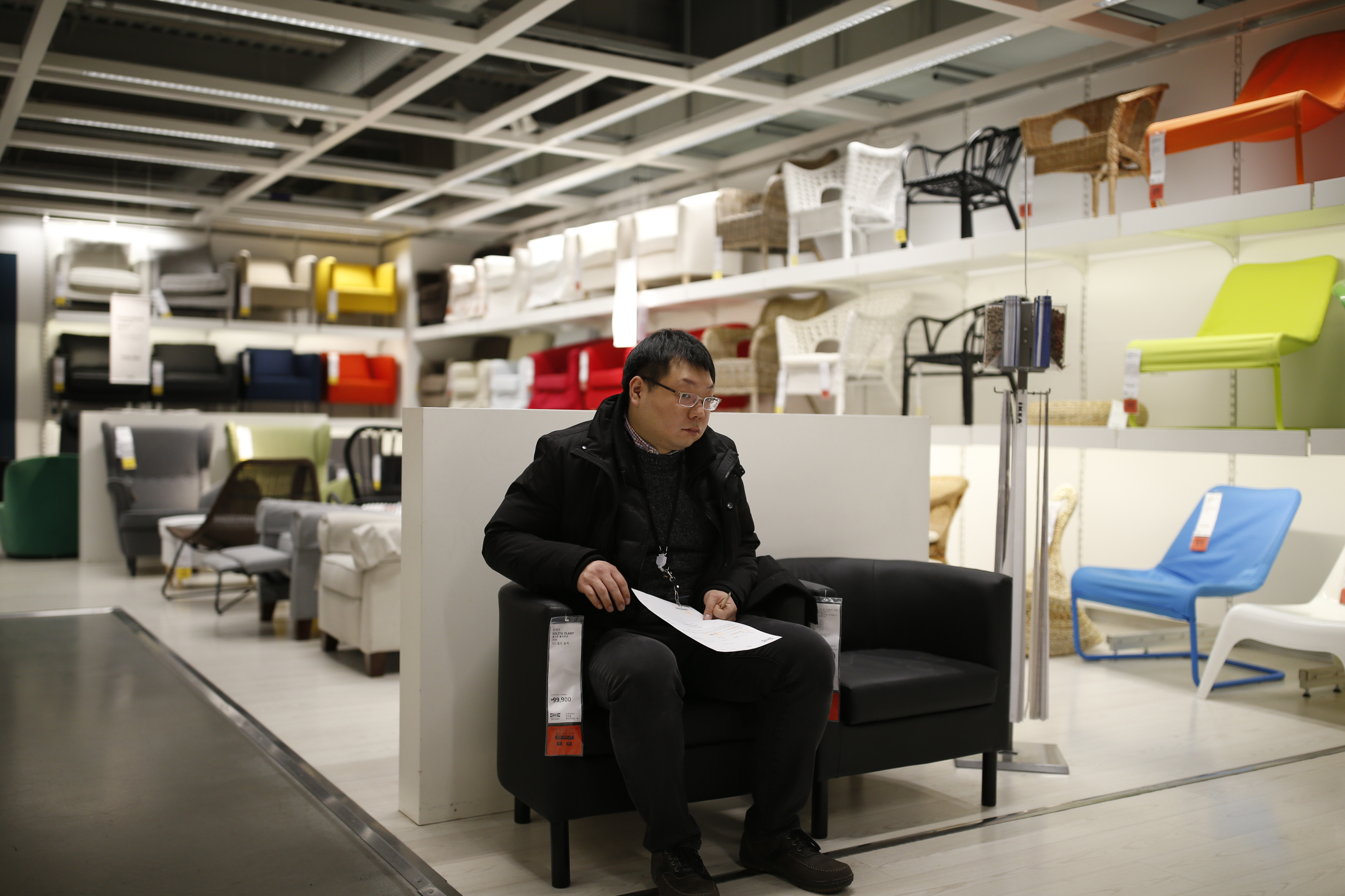 A man tries out a sofa at an Ikea store in Gwangmyeong