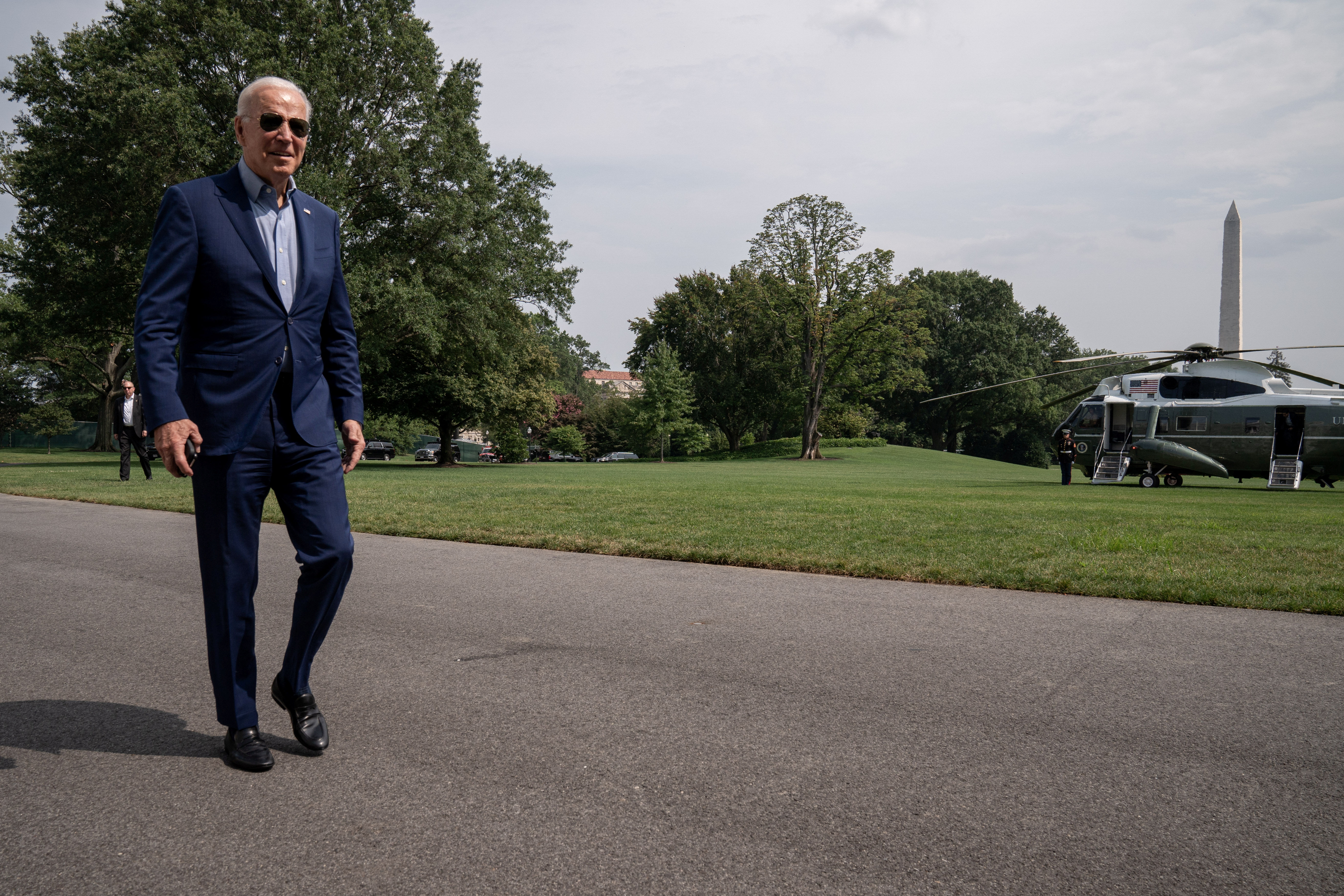 U.S. President Joe Biden walks after exiting Marine One upon his return from Wilmington, Delaware, on the South Lawn at the White House in Washington, U.S., July 25, 2021. REUTERS/Ken Cedeno