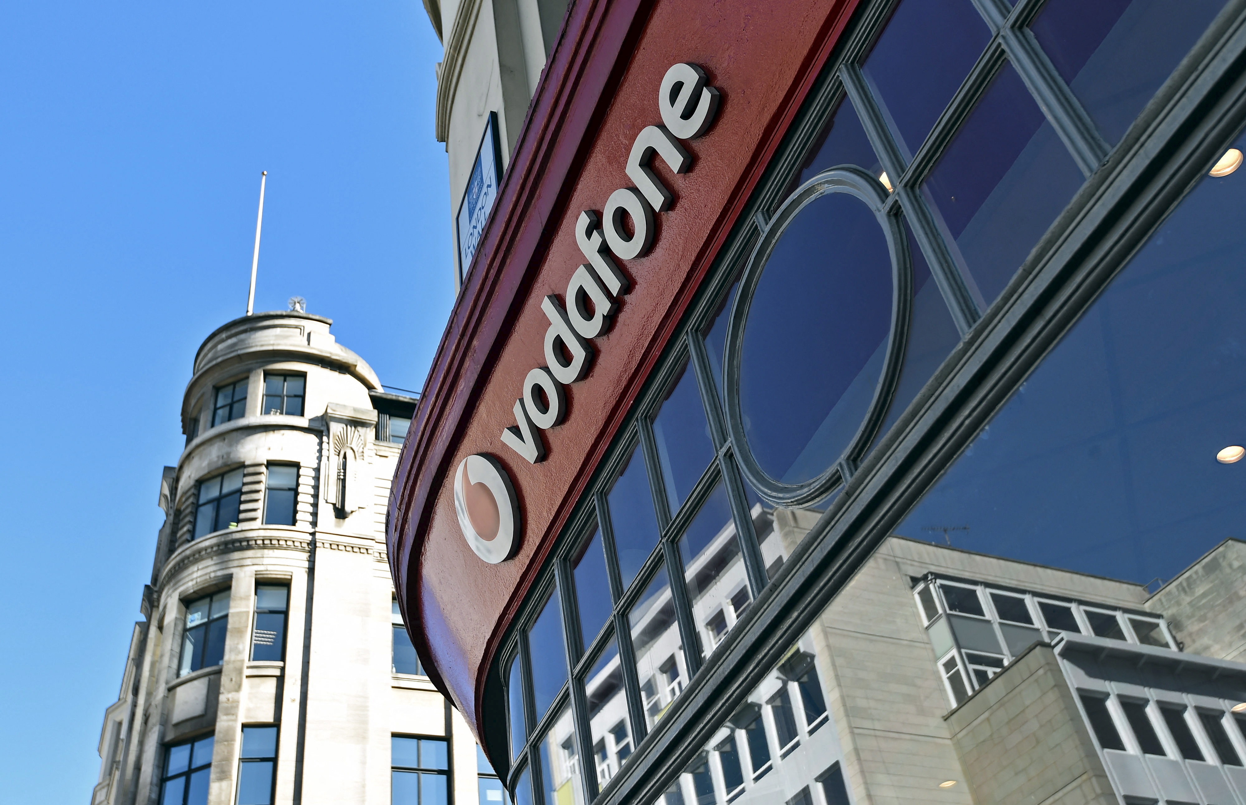 Branding for Vodafone is seen on the exterior of a shop in London, Britain