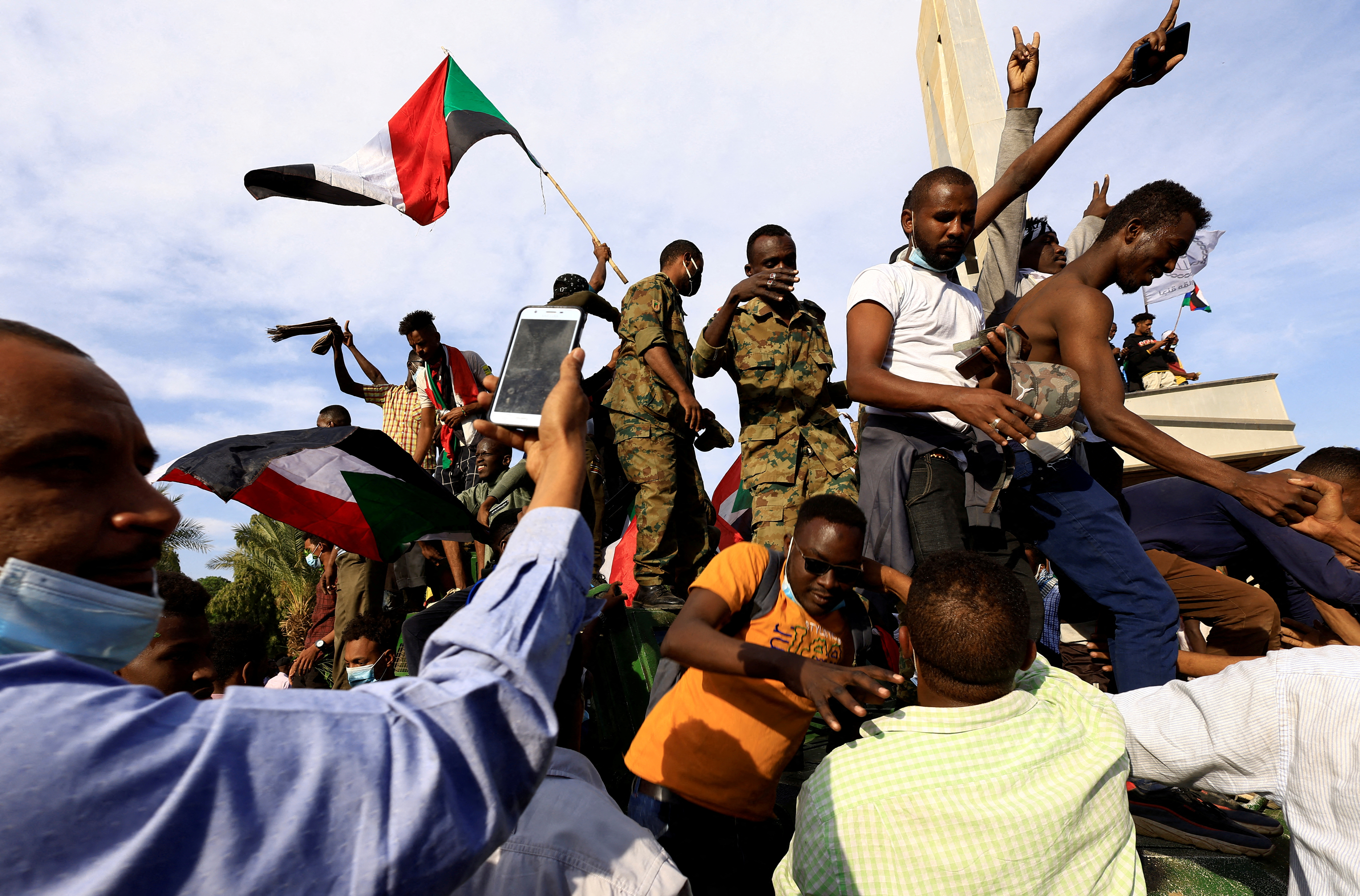 Protesters celebrate reaching the presidential palace in Khartoum
