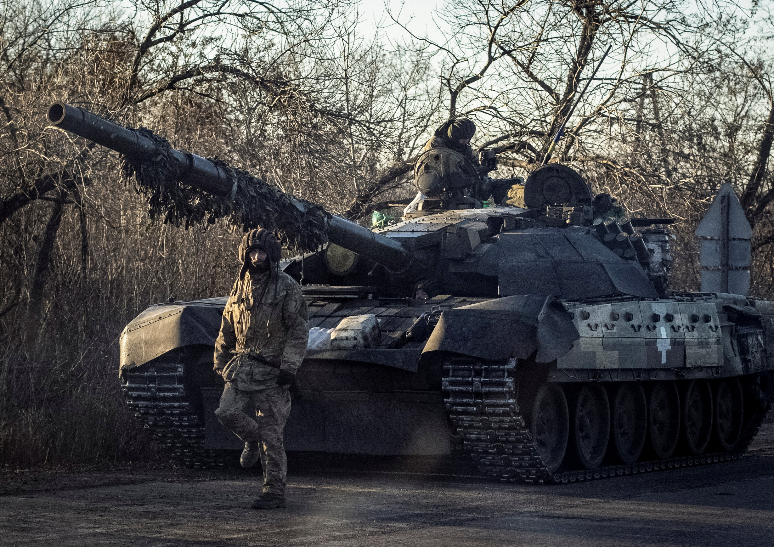 Ukrainian serviceman walks near a tank in Bakhmut