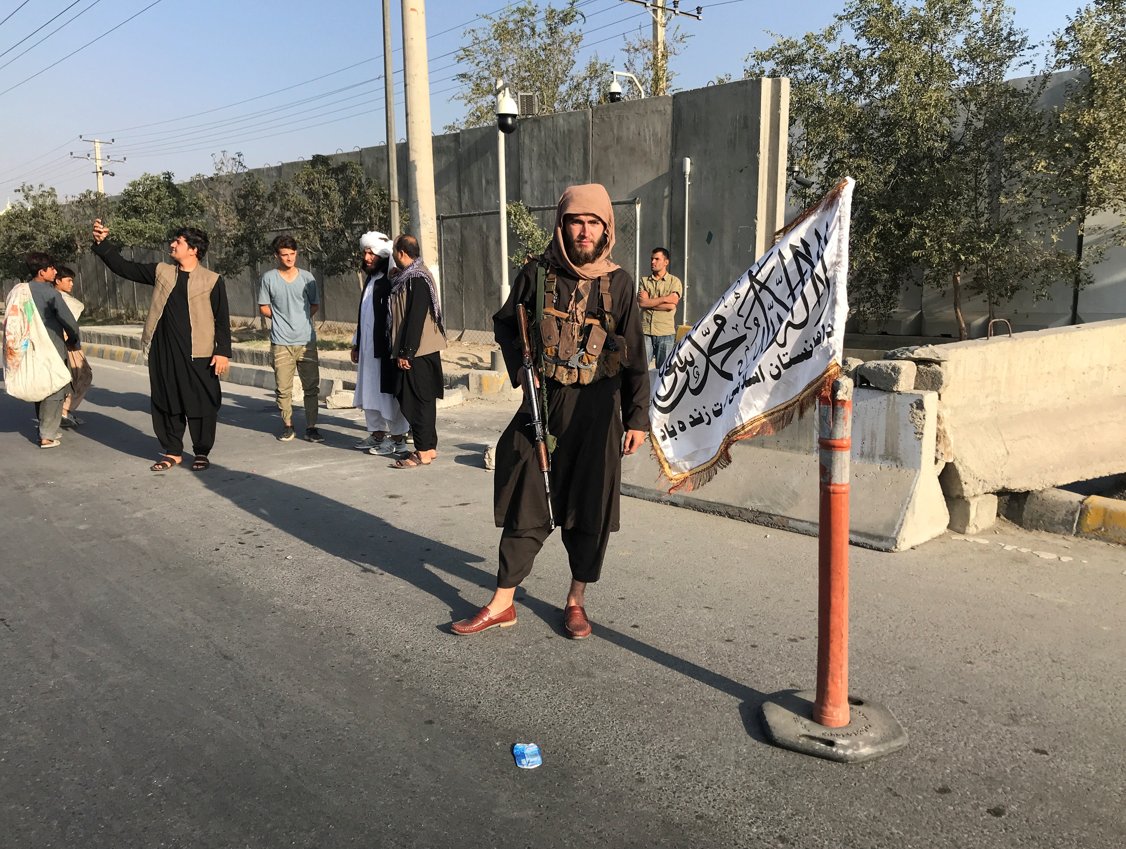 A member of Taliban stands outside the Interior Ministry in Kabul