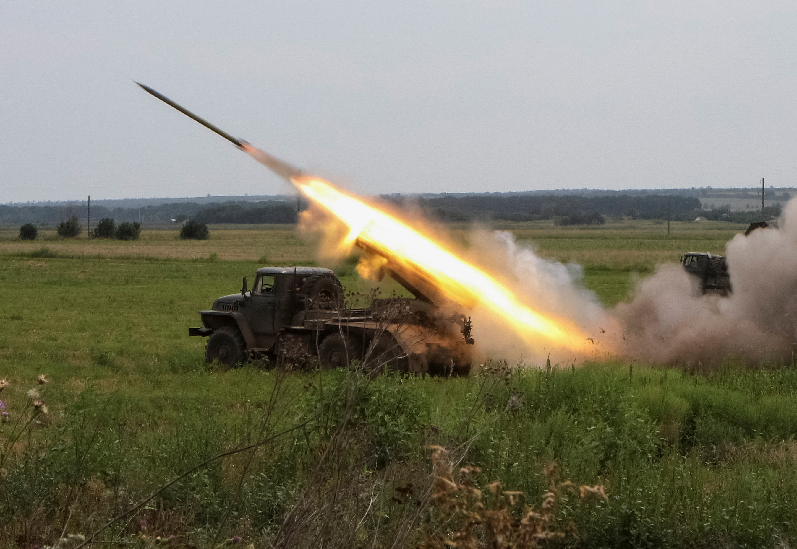 Ukrainian servicemen fire with a BM21 Grad multiple launch rocket system in a frontline in Kharkiv region