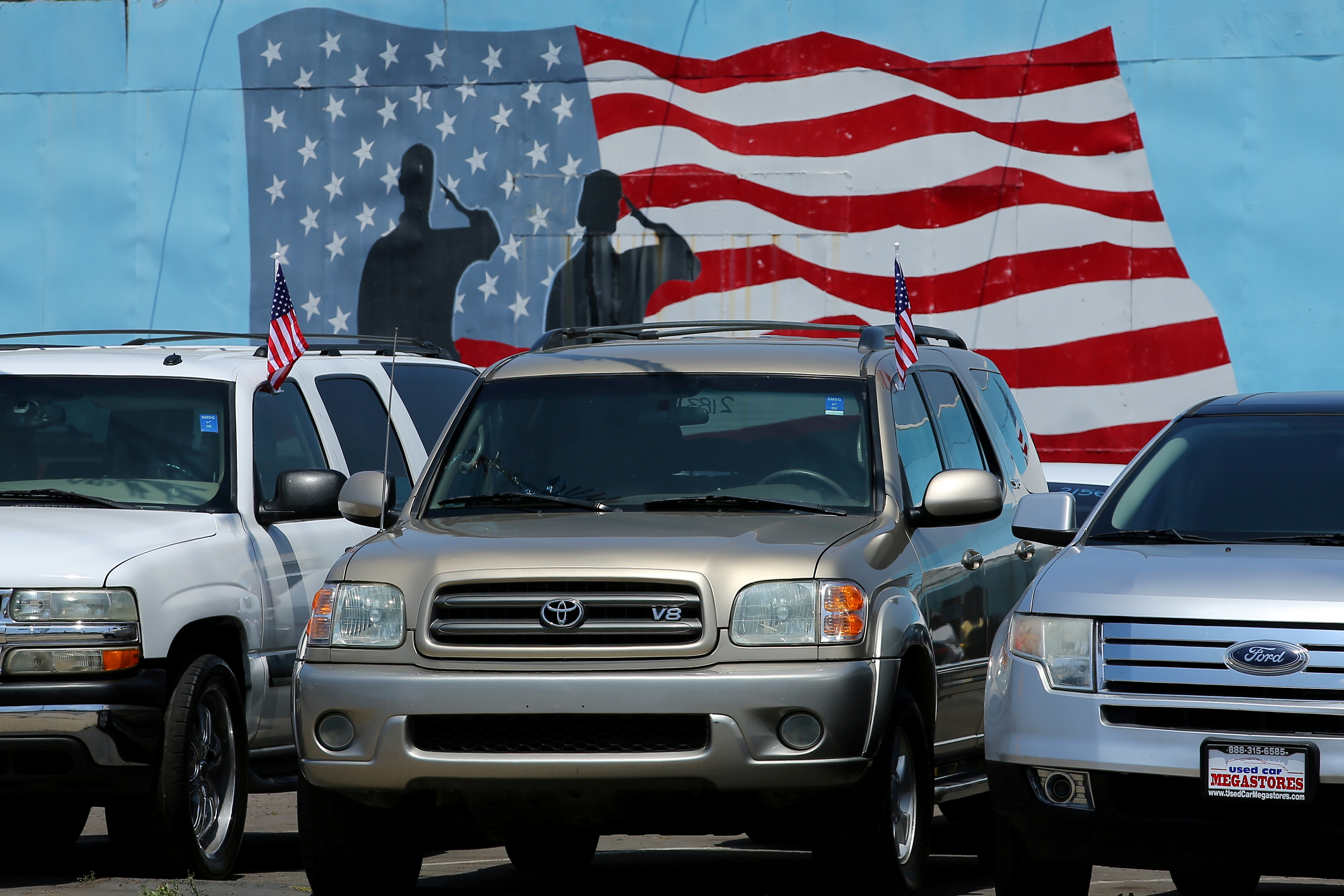 Cars are shown for sale with financing at a car lot in National City, California