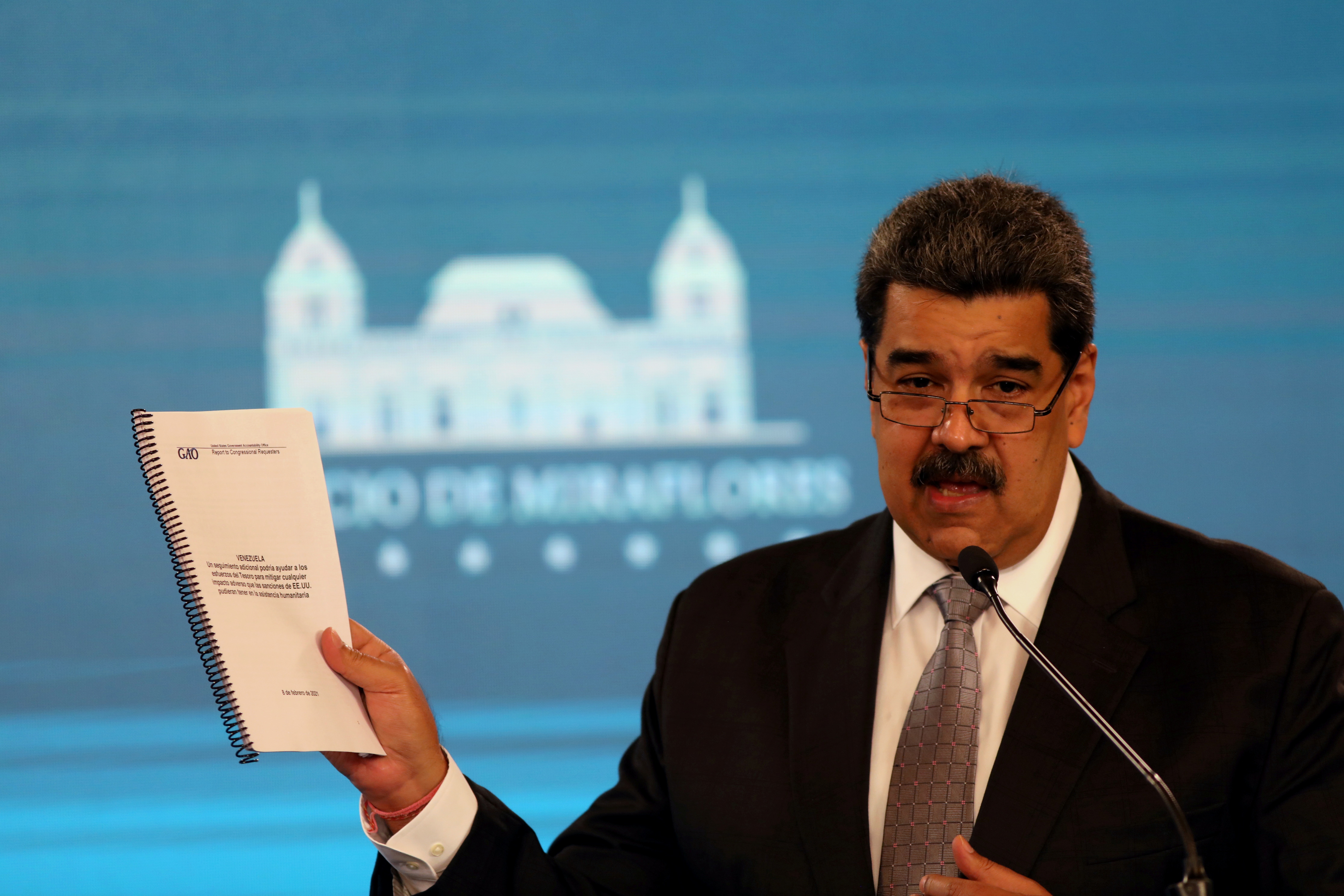 Venezuela's President Maduro shows a document from the government administration office during a news conference in Caracas