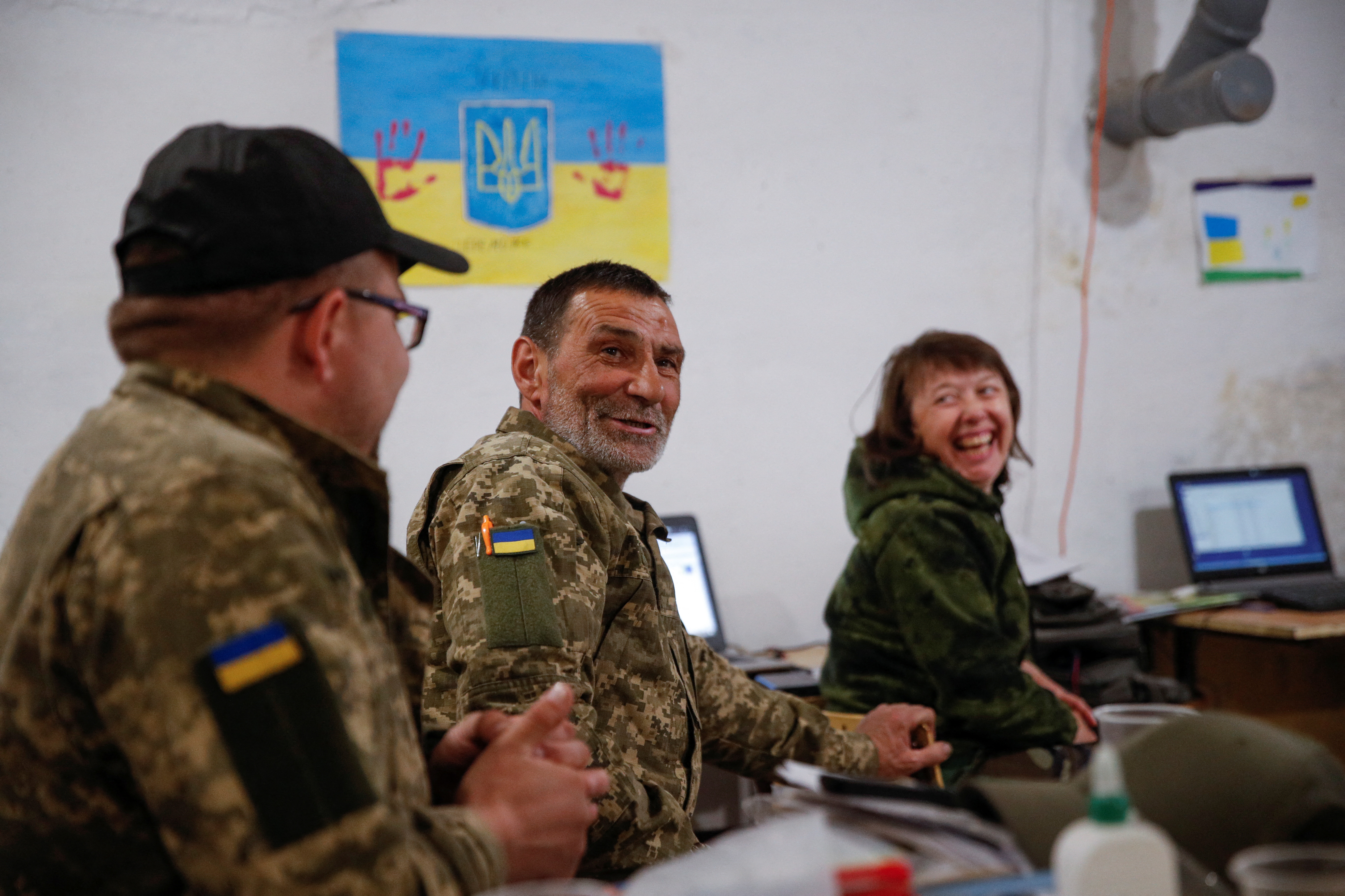 Ukrainian service members watch 2022 Eurovision Song Contest at a position in Kyiv region