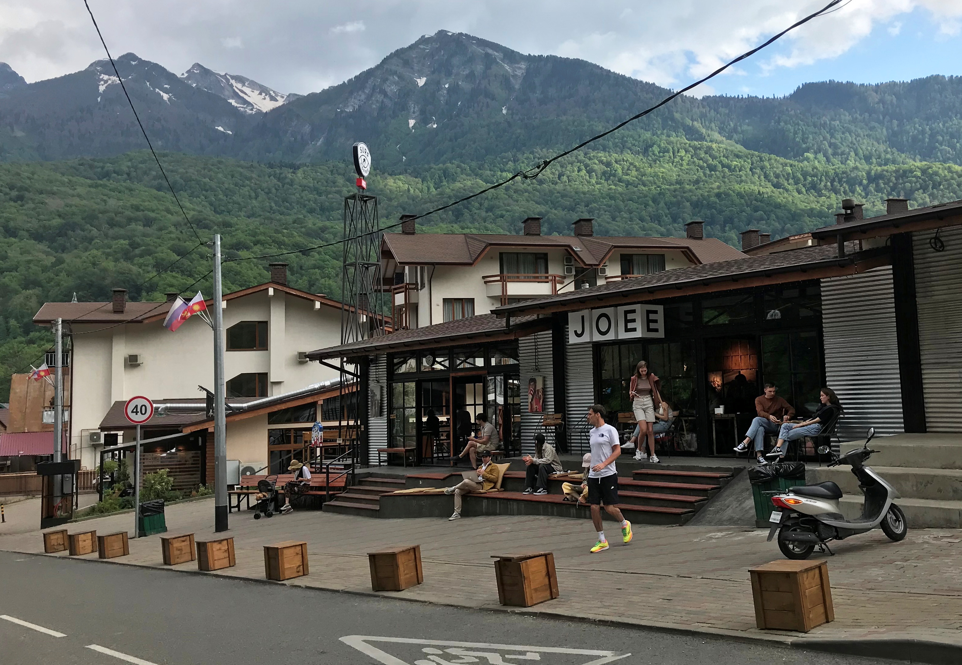 People are seen at a cafe in the village of Krasnaya Polyana