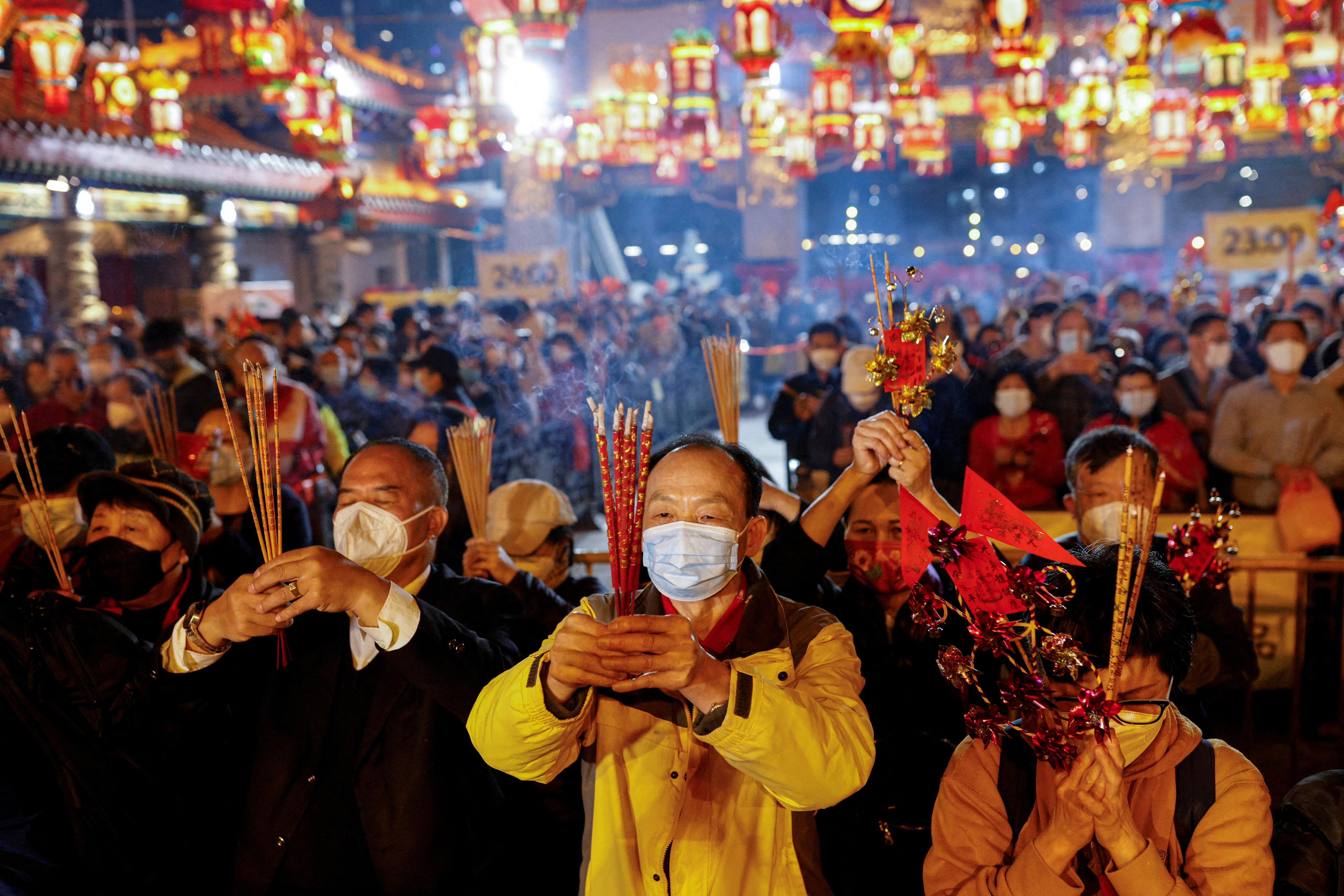 Devotees make their offerings inside the Wong Tai Sin Temple to celebrate the Lunar New Year, Hong Kong