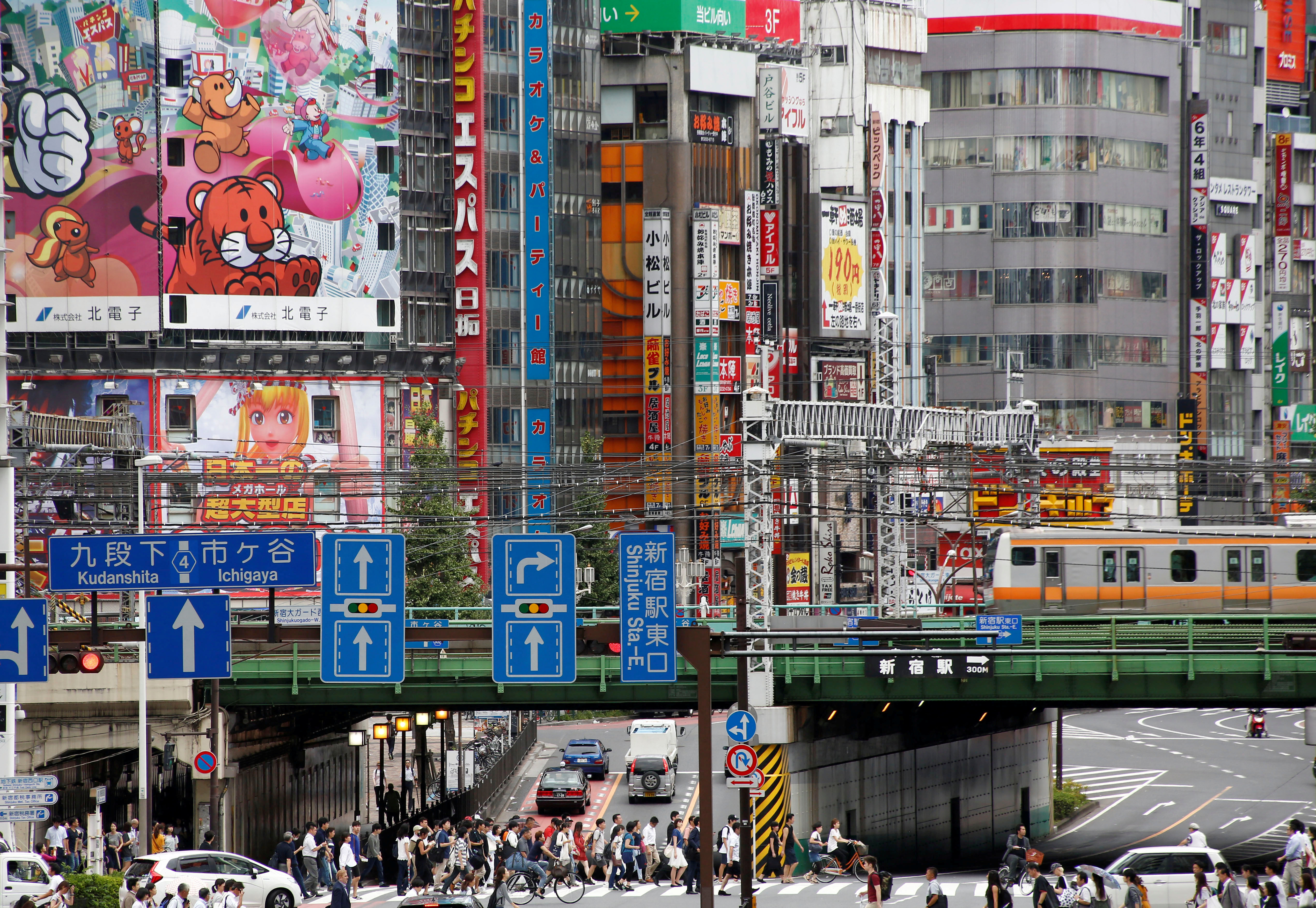 People cross the street  at a shopping district  in Tokyo