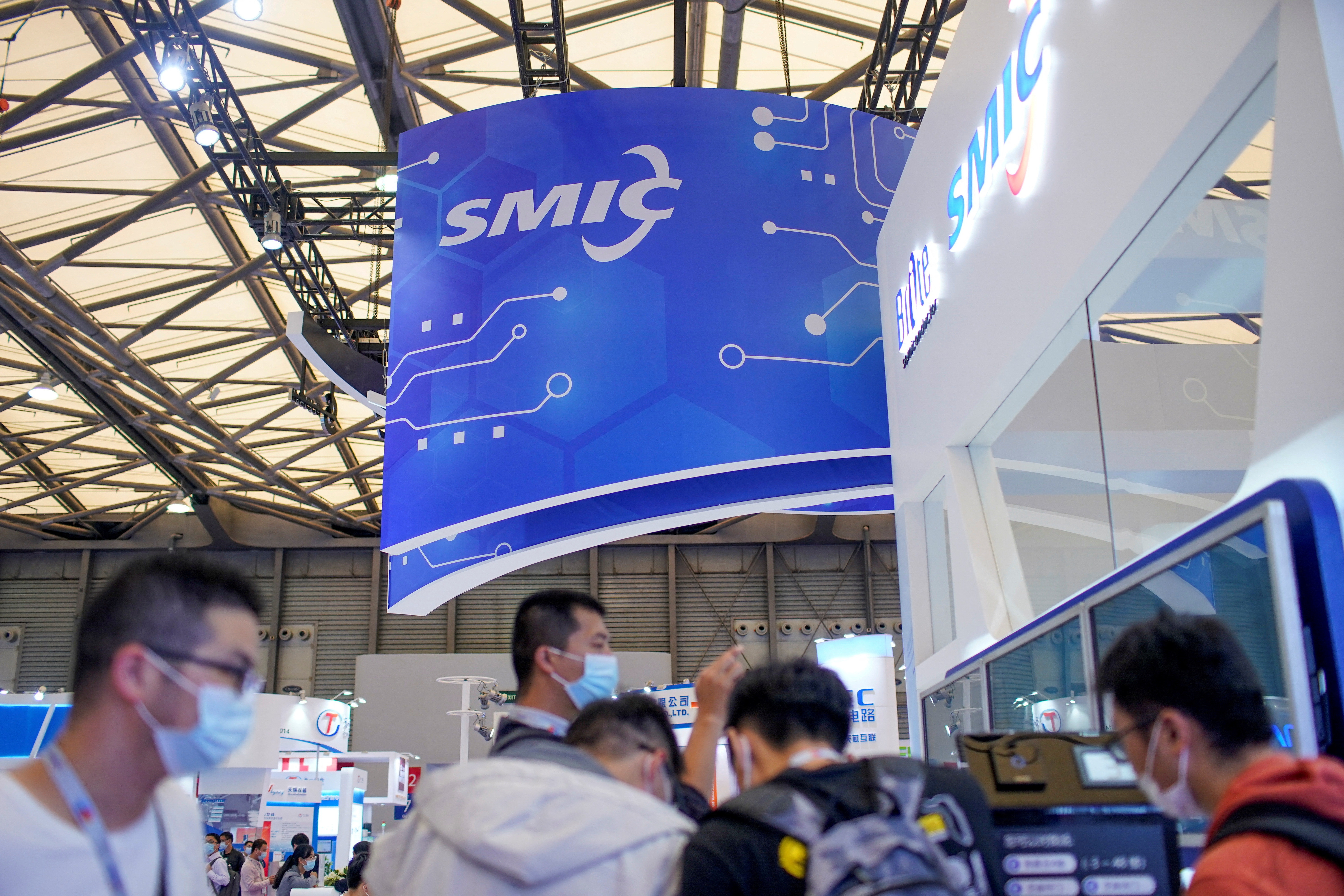 People visit a booth of Semiconductor Manufacturing International Corporation (SMIC), at China International Semiconductor Expo (IC China 2020) following the coronavirus disease (COVID-19) outbreak in Shanghai