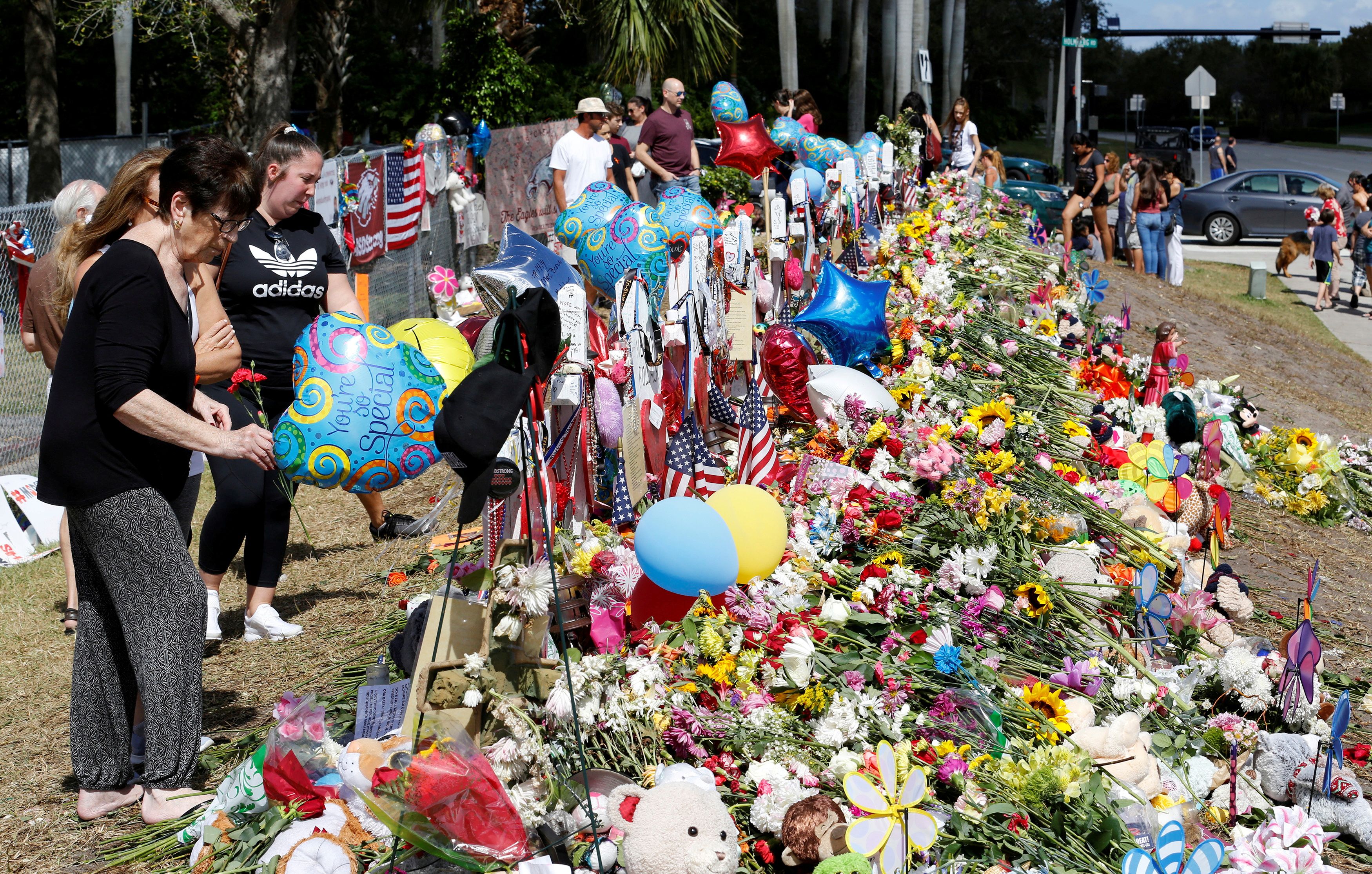 Visitors view memorials at Marjory Stoneman Douglas High School in Parkland, Florida, U.S. February 24, 2018. REUTERS/Joe Skipper/File Photo