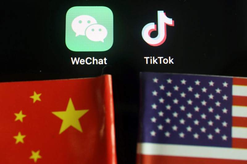 Illustration picture of Wechat and TikTok apps near China and U.S. flags